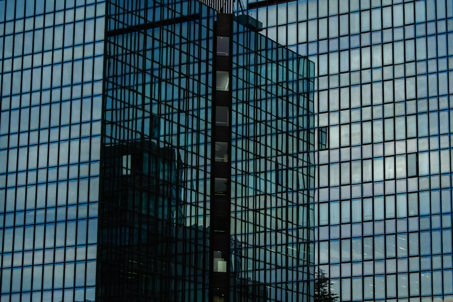 Reflections of a glass building with blue sky patterns