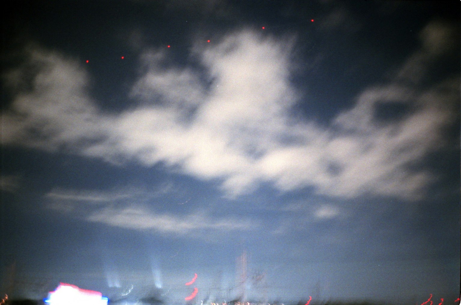 Cielo nocturno con nubes y puntos de luz