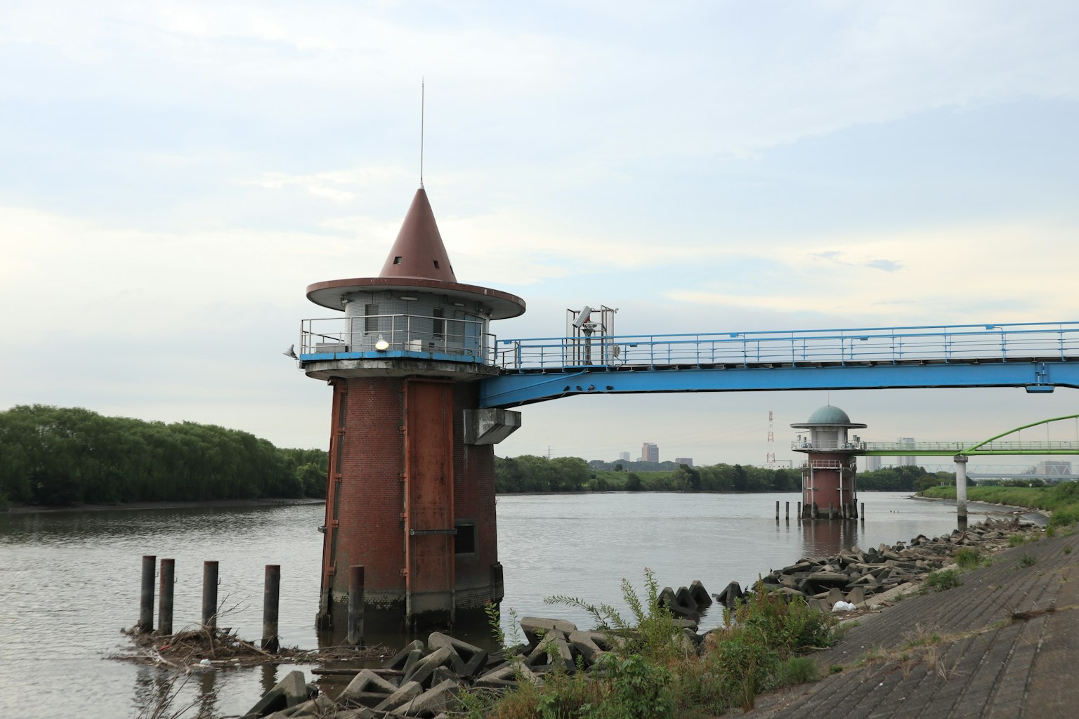 Red tower with a blue bridge near the river
