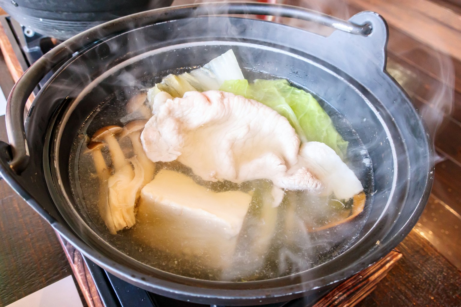 Hot pot with vegetables tofu and meat steaming