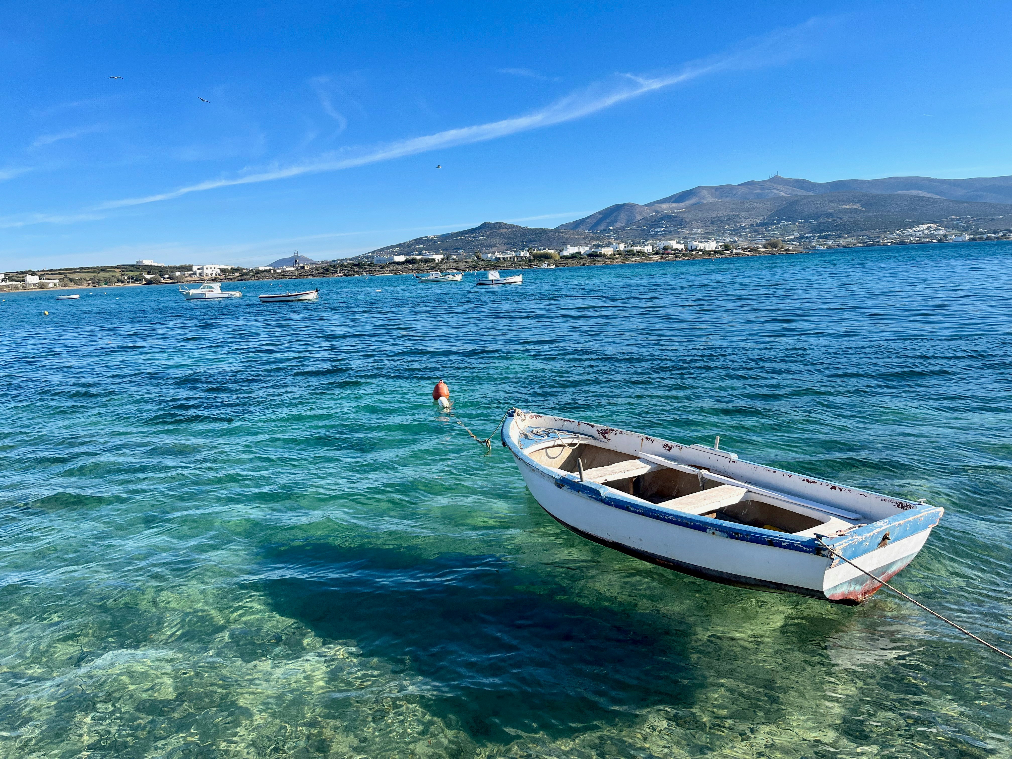 Antiparos harbor scene with clear Aegean sea and a small boat