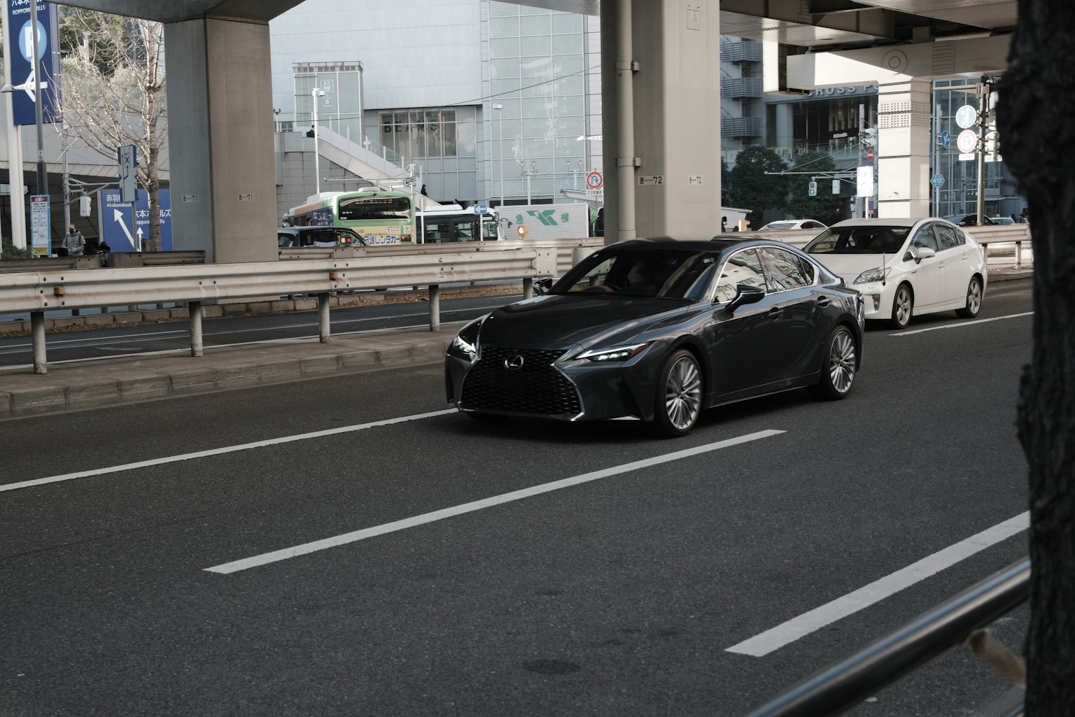 Une voiture noire circulant sur une route urbaine