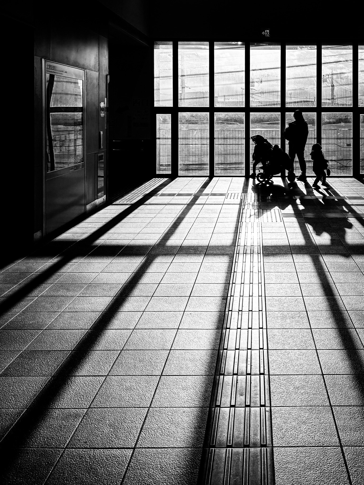shadows falling on a station corridor at the west exit