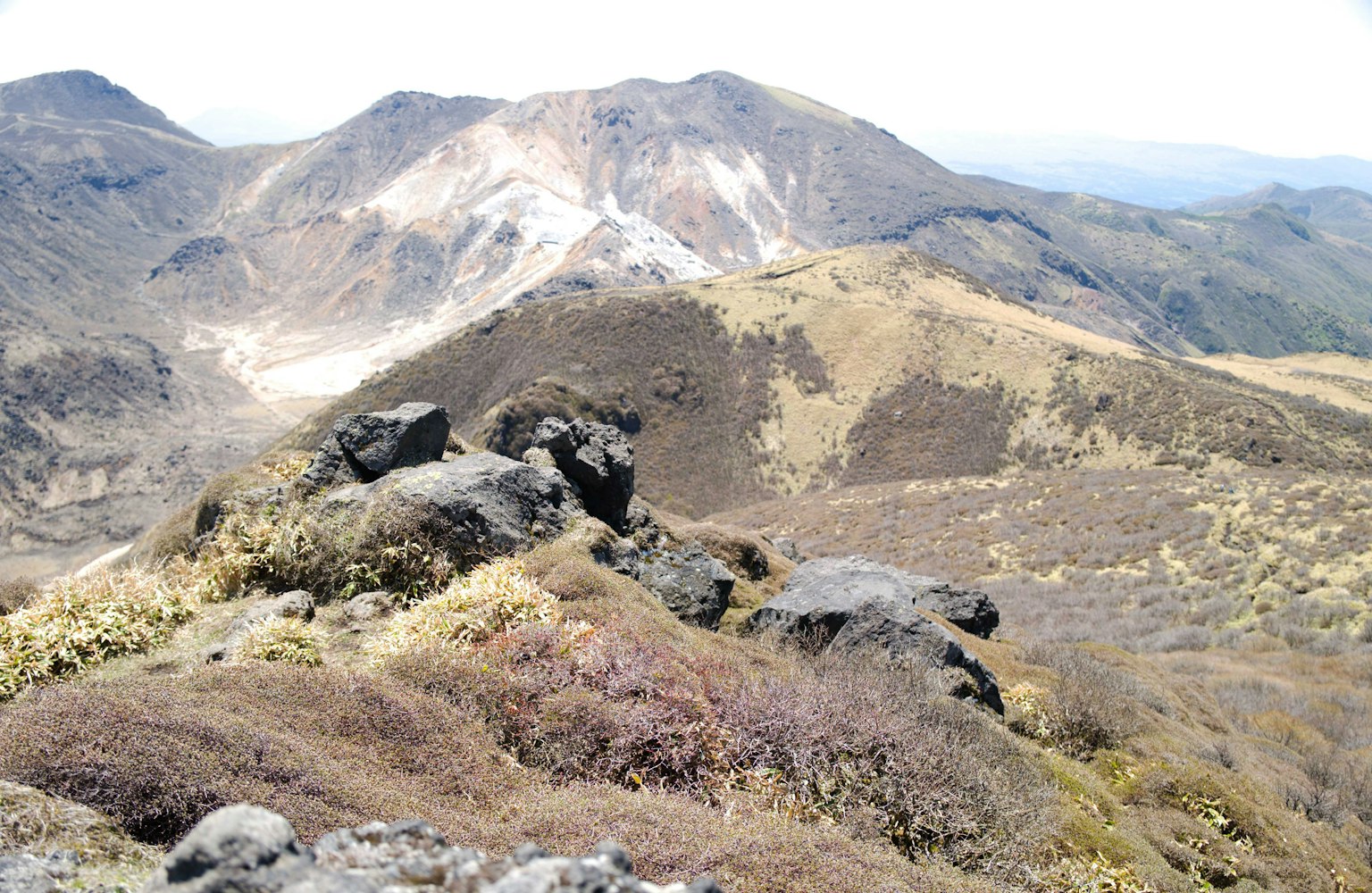 Mountain landscape featuring exposed rocks and vegetation