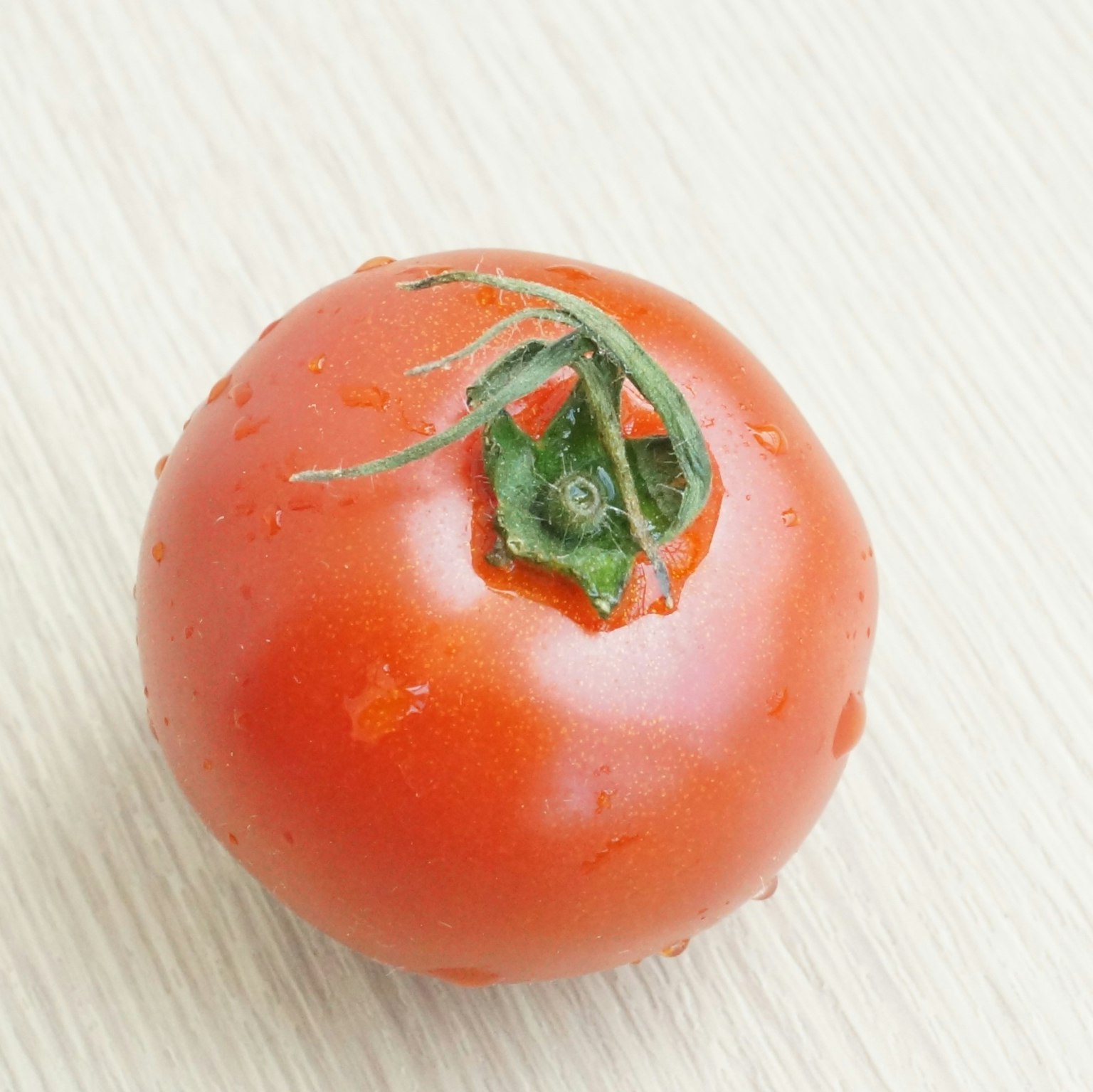 Frische reife Tomate auf einer Holzoberfläche platziert