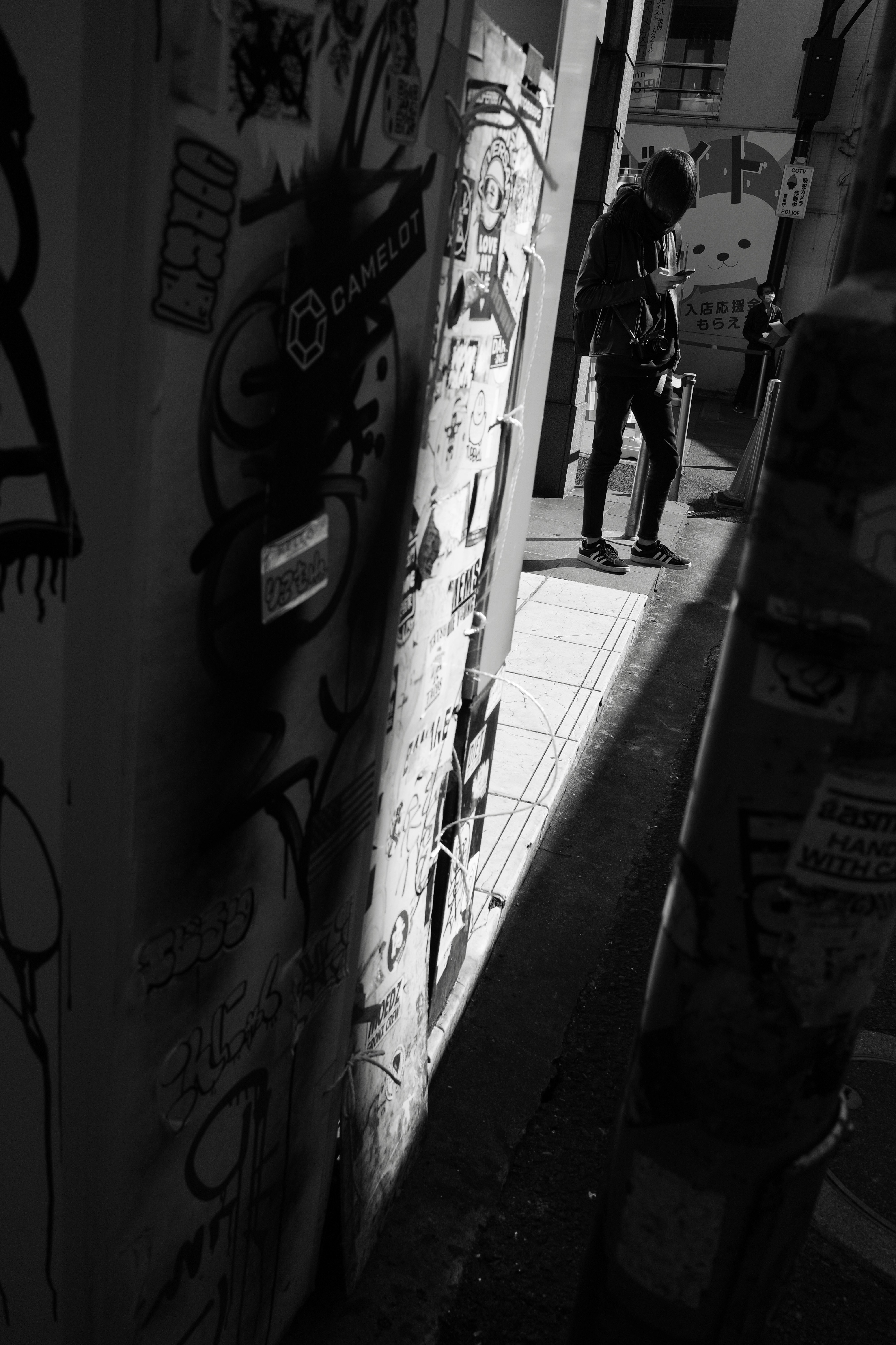 dim alley passage with graffiti-covered wall