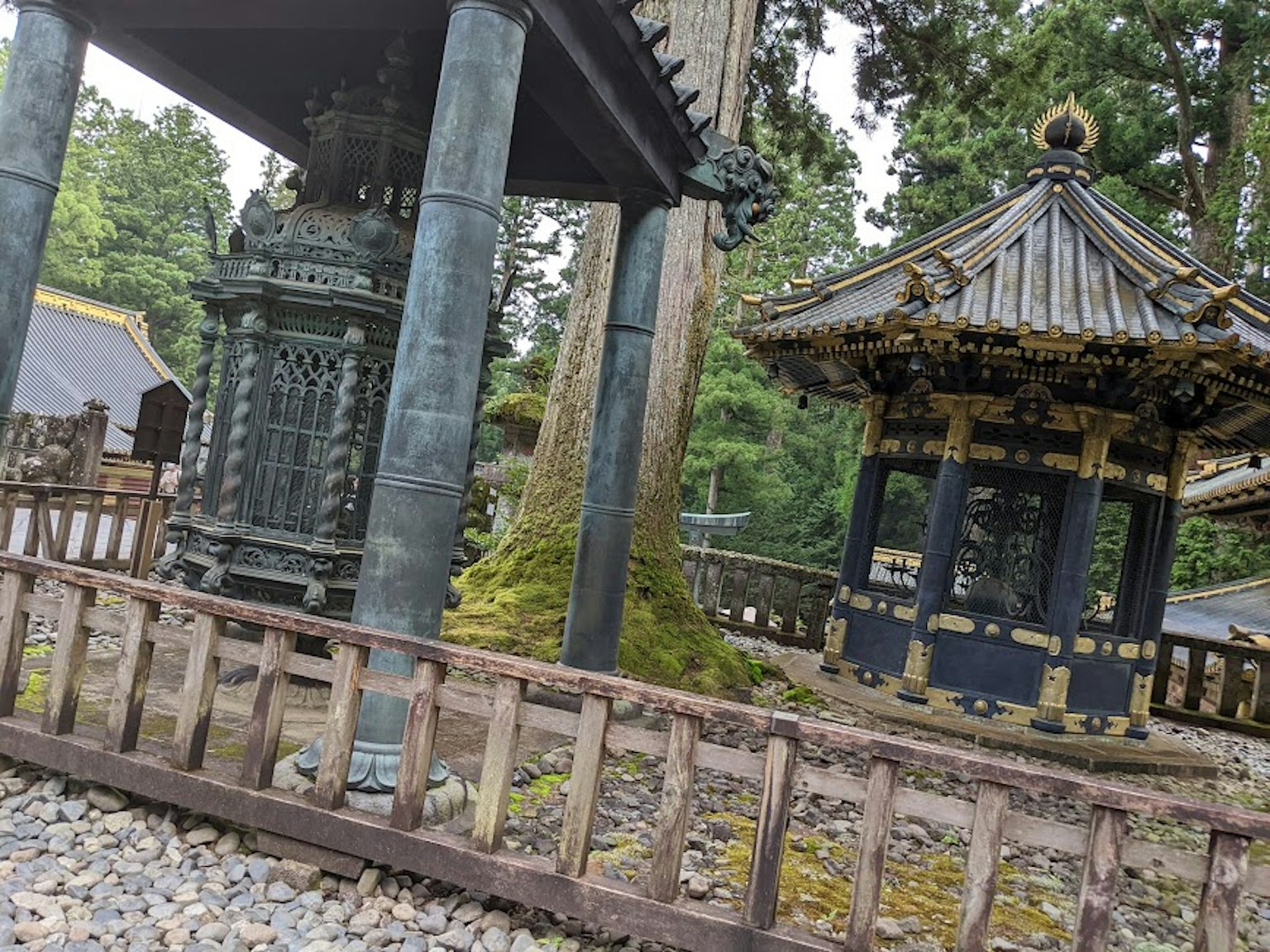 传统神社建筑与石钟在宁静森林环境中