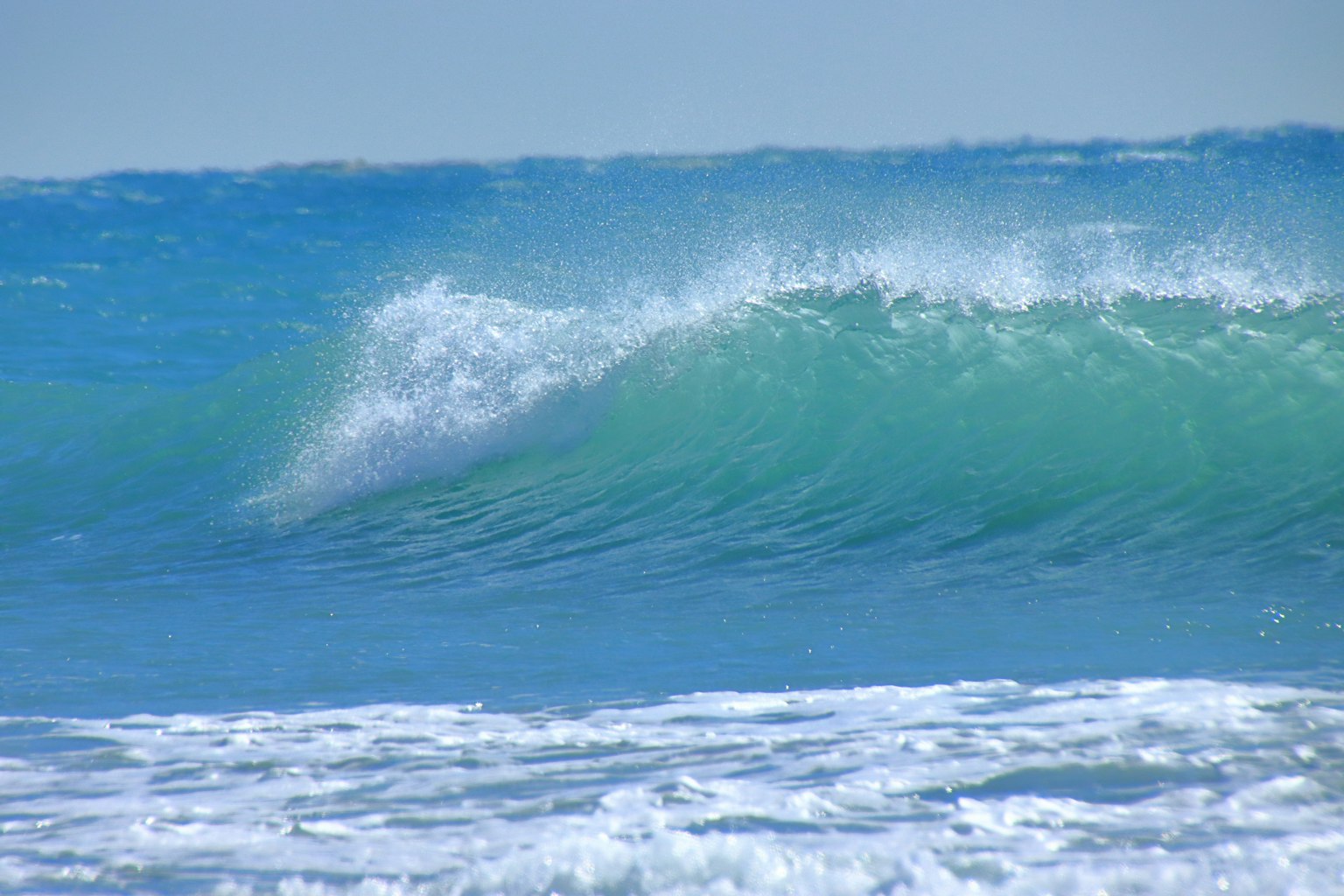 Vagues douces de l'océan bleu se brisant sur le rivage