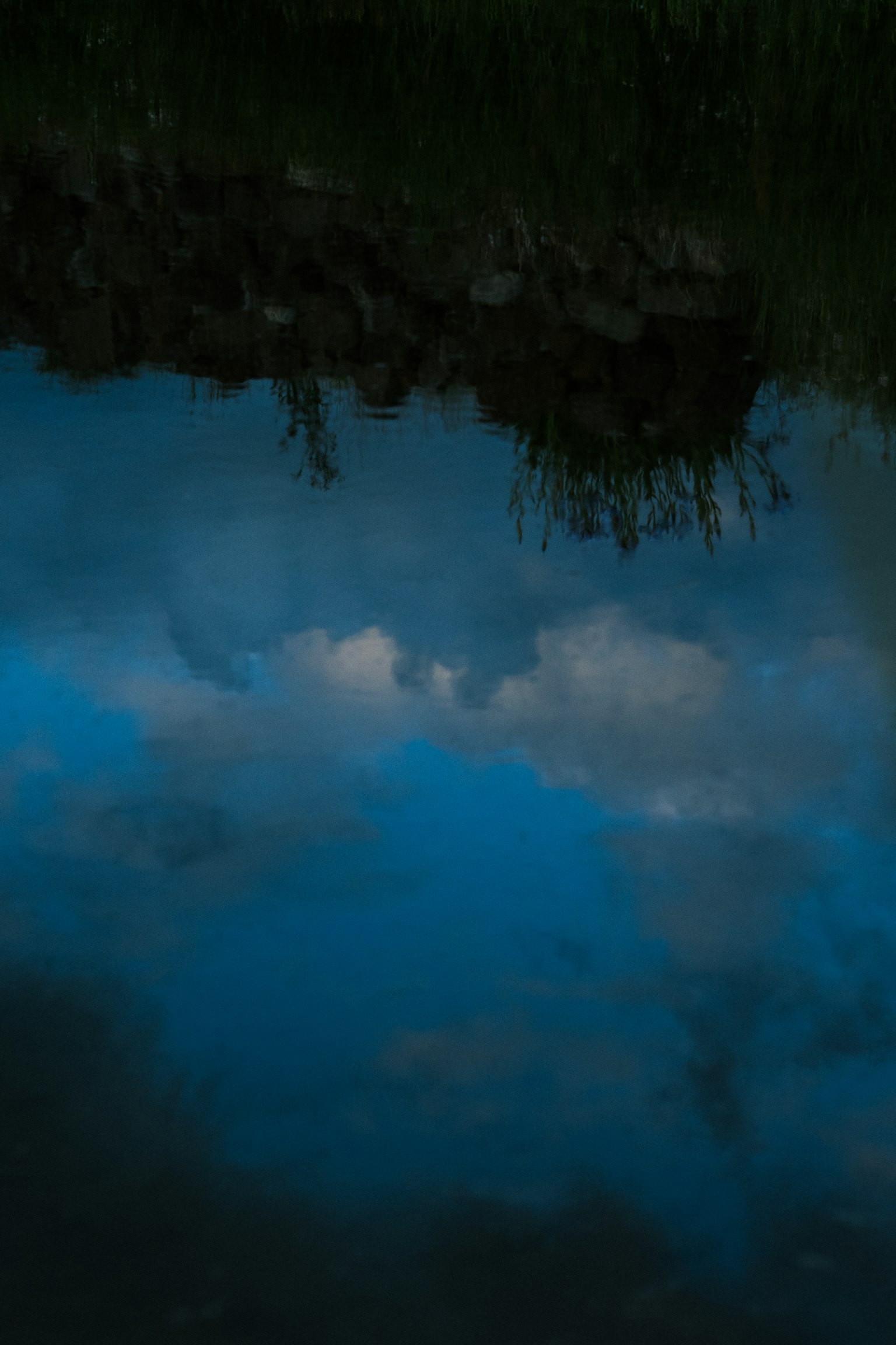 Reflection of blue sky and clouds on water surface