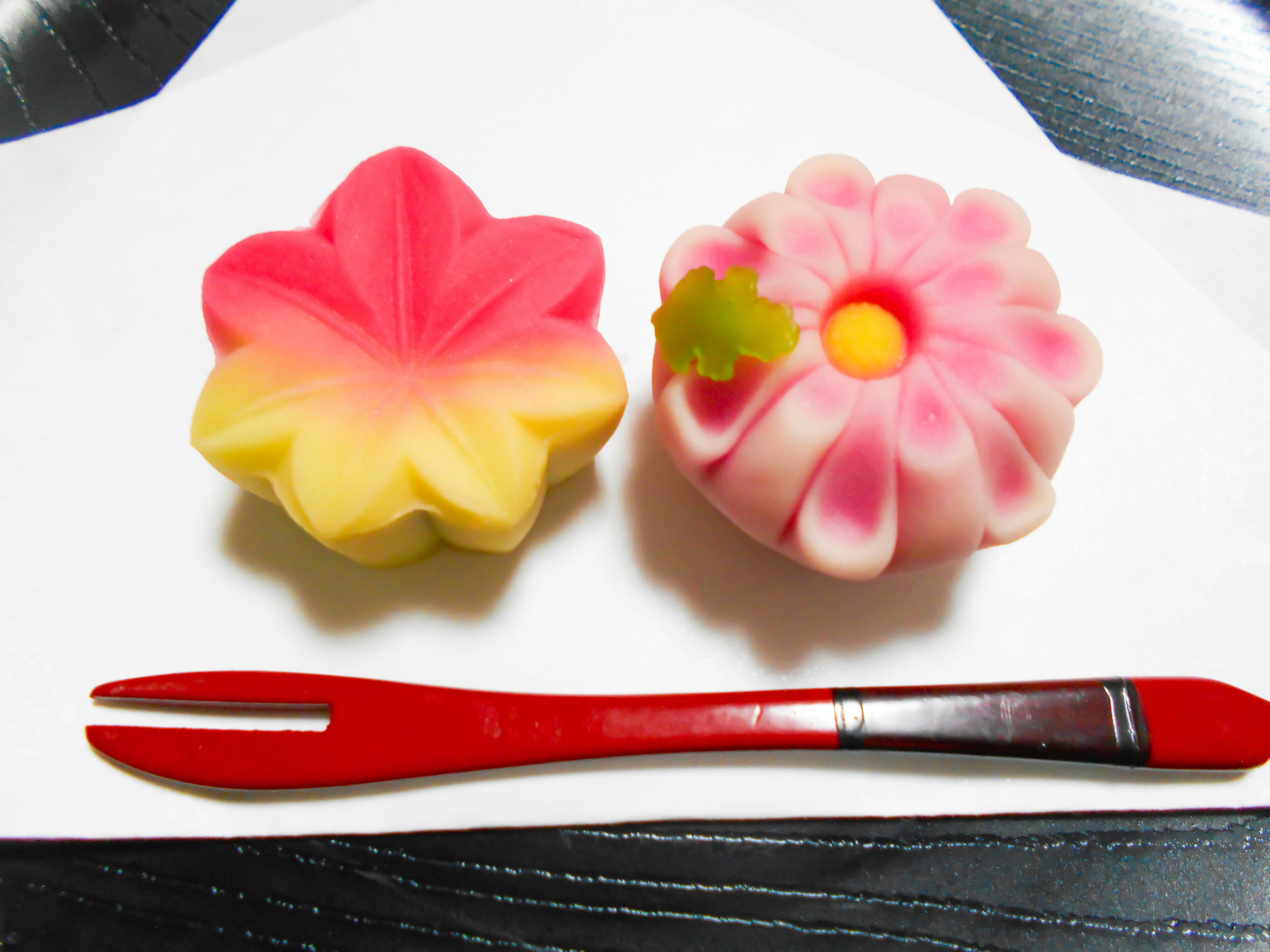 flower-shaped soaps and a red pen on a white tray