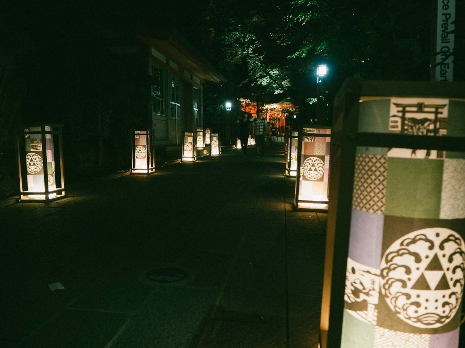 Traditional lanterns illuminating a pathway at night