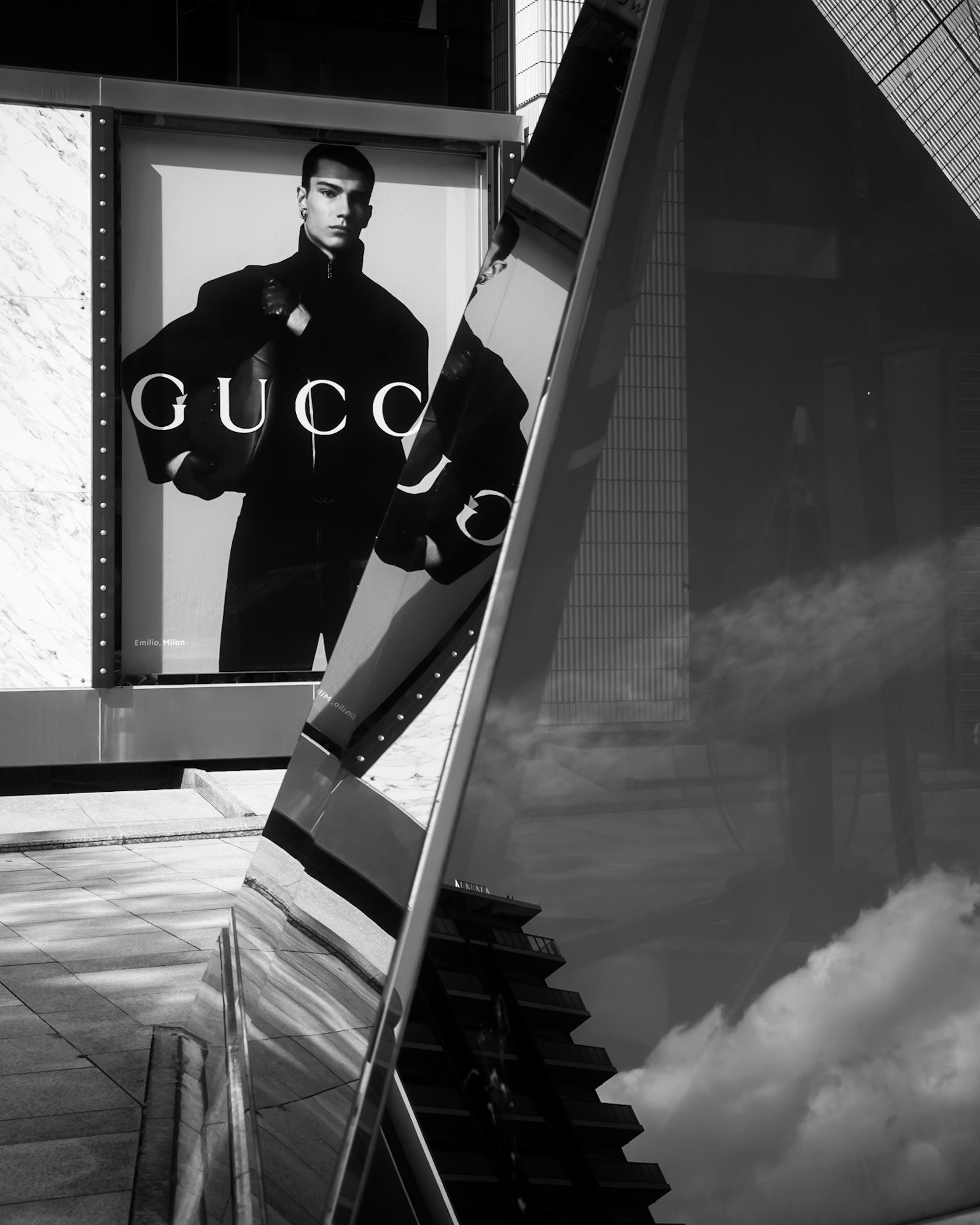 Poster pubblicitario Gucci con un modello e architettura moderna riflettente