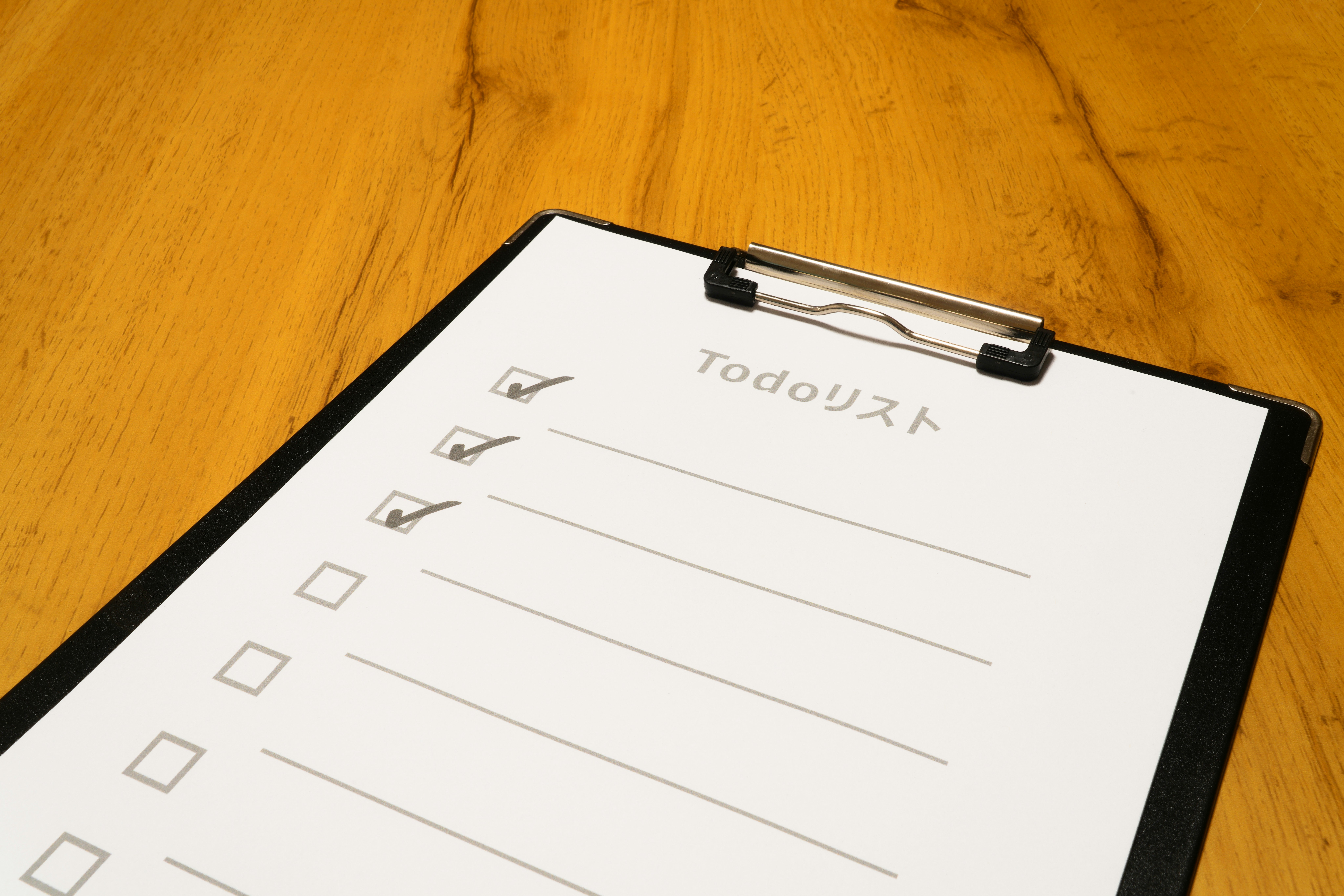 clipboard with document on a wooden desk