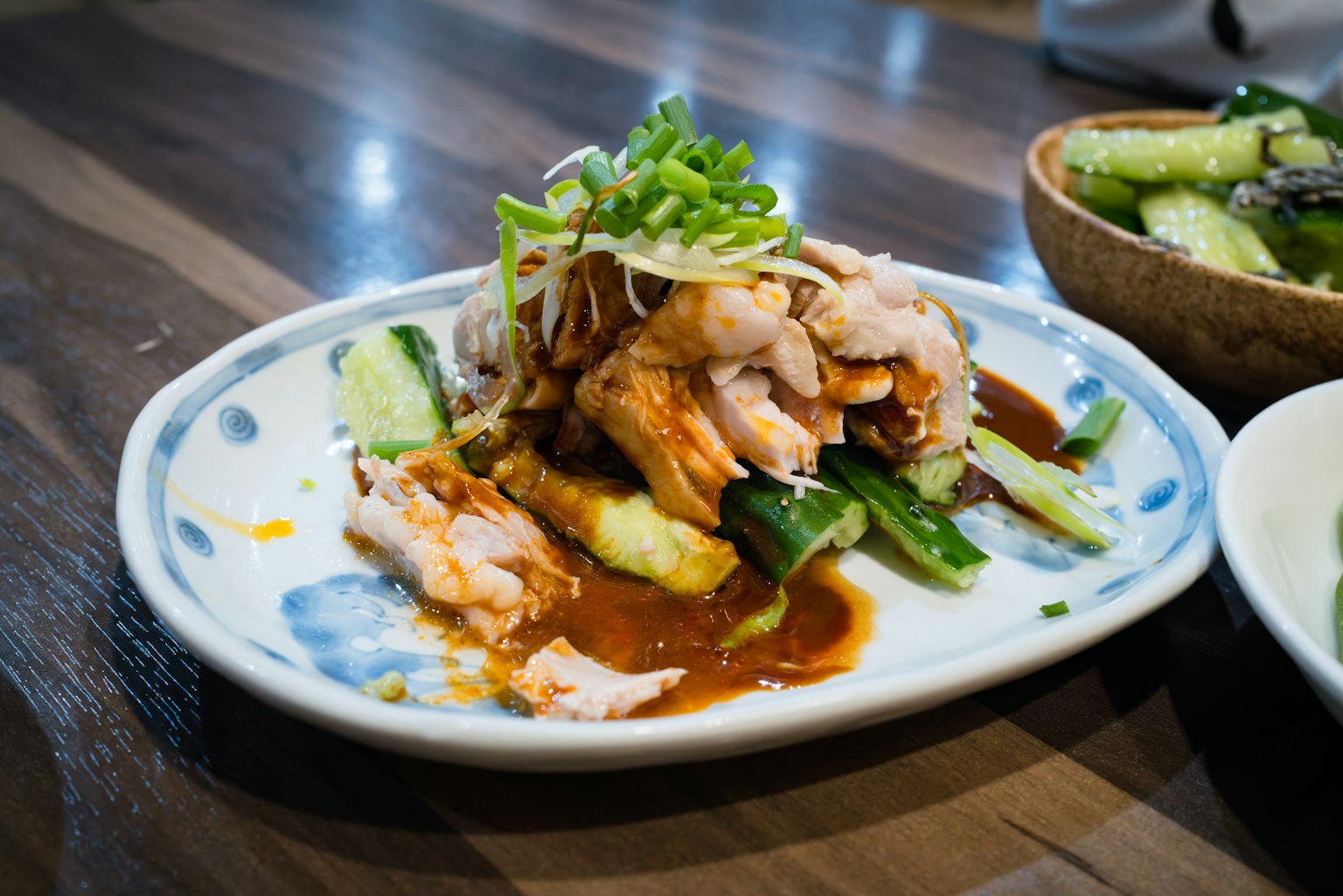 Plate of chicken and vegetables garnished with scallions