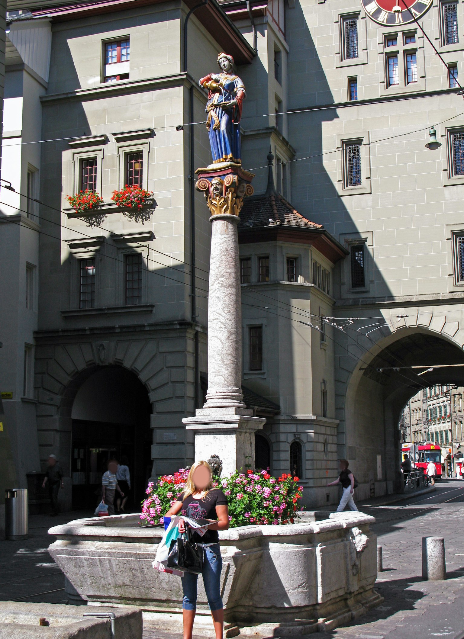 Une fontaine avec une belle statue dans une place de ville