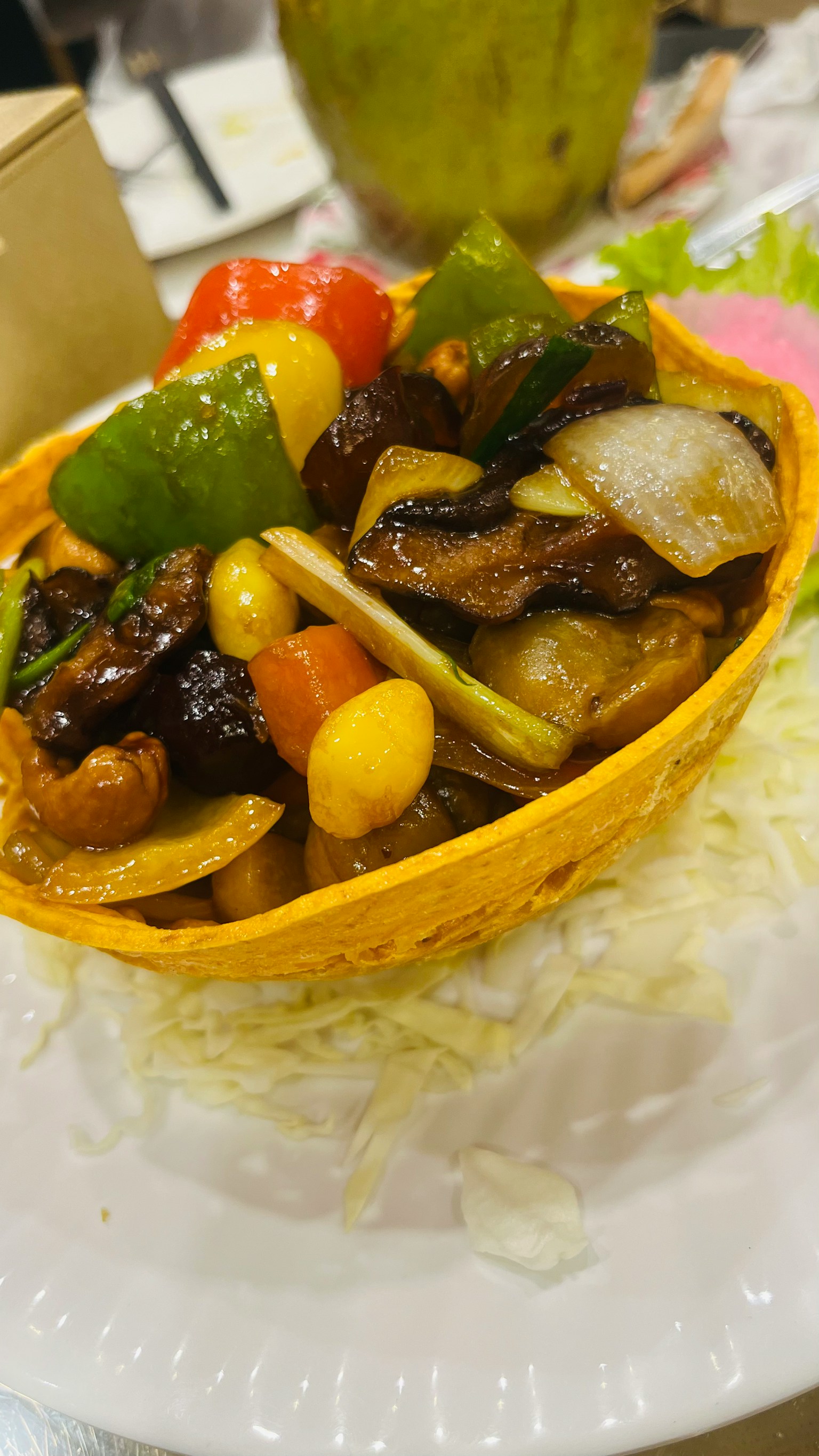 Colorful stir-fried vegetables and meat served in an edible basket