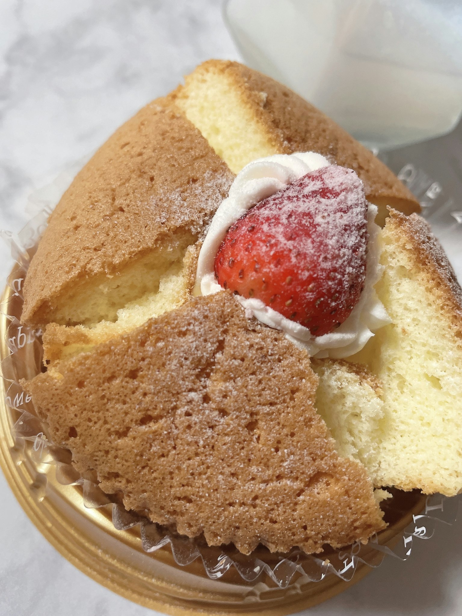 Sezione trasversale di una torta appena sfornata con crema e fragola