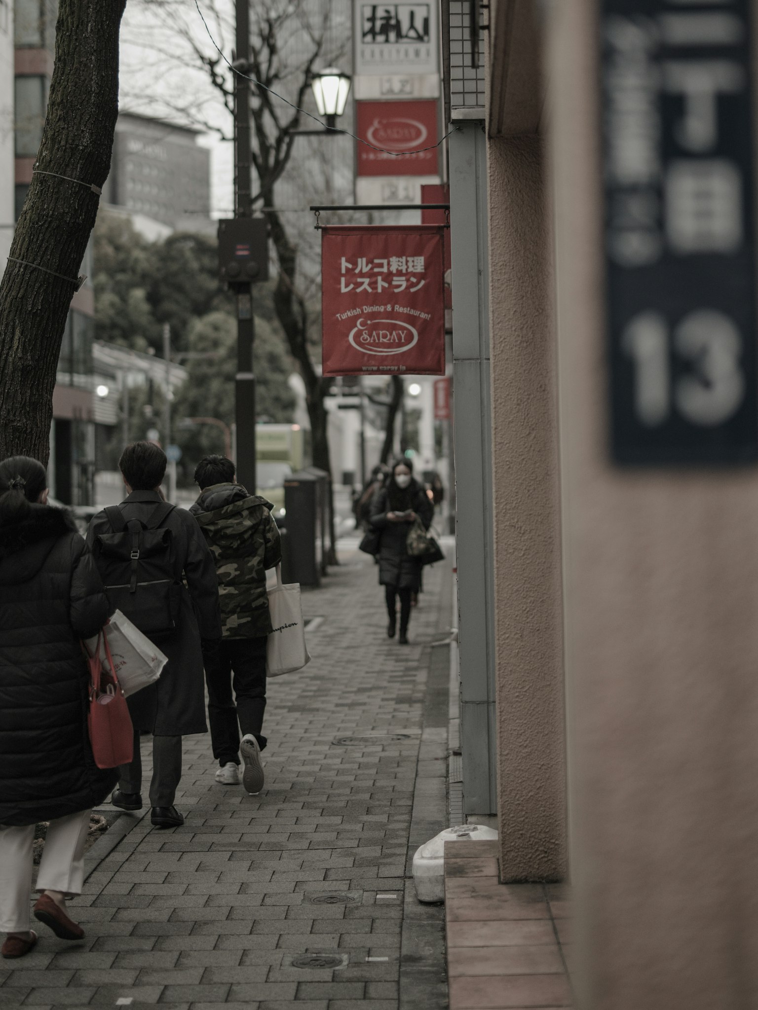 Street scene featuring pedestrians and signage