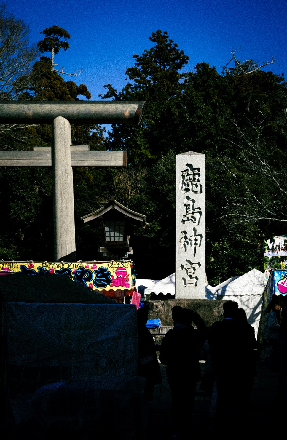 鹿島神宮の鳥居前で行われる屋外の祭りの出店と提灯