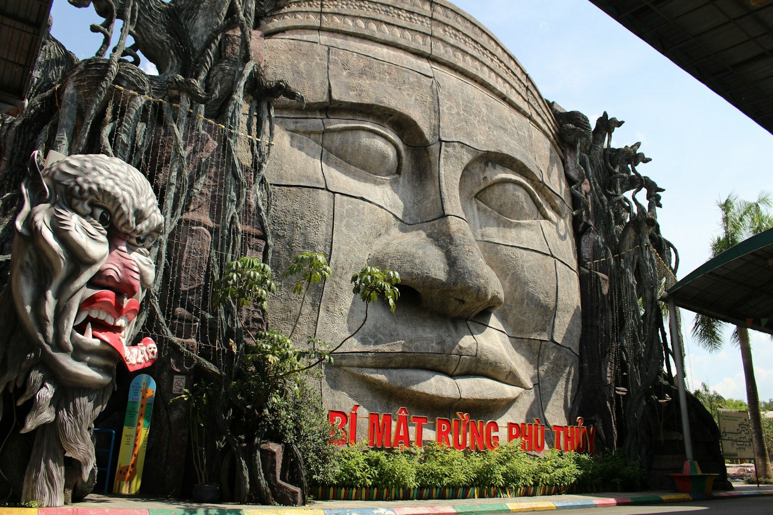 Entrance of a theme park featuring a large face sculpture