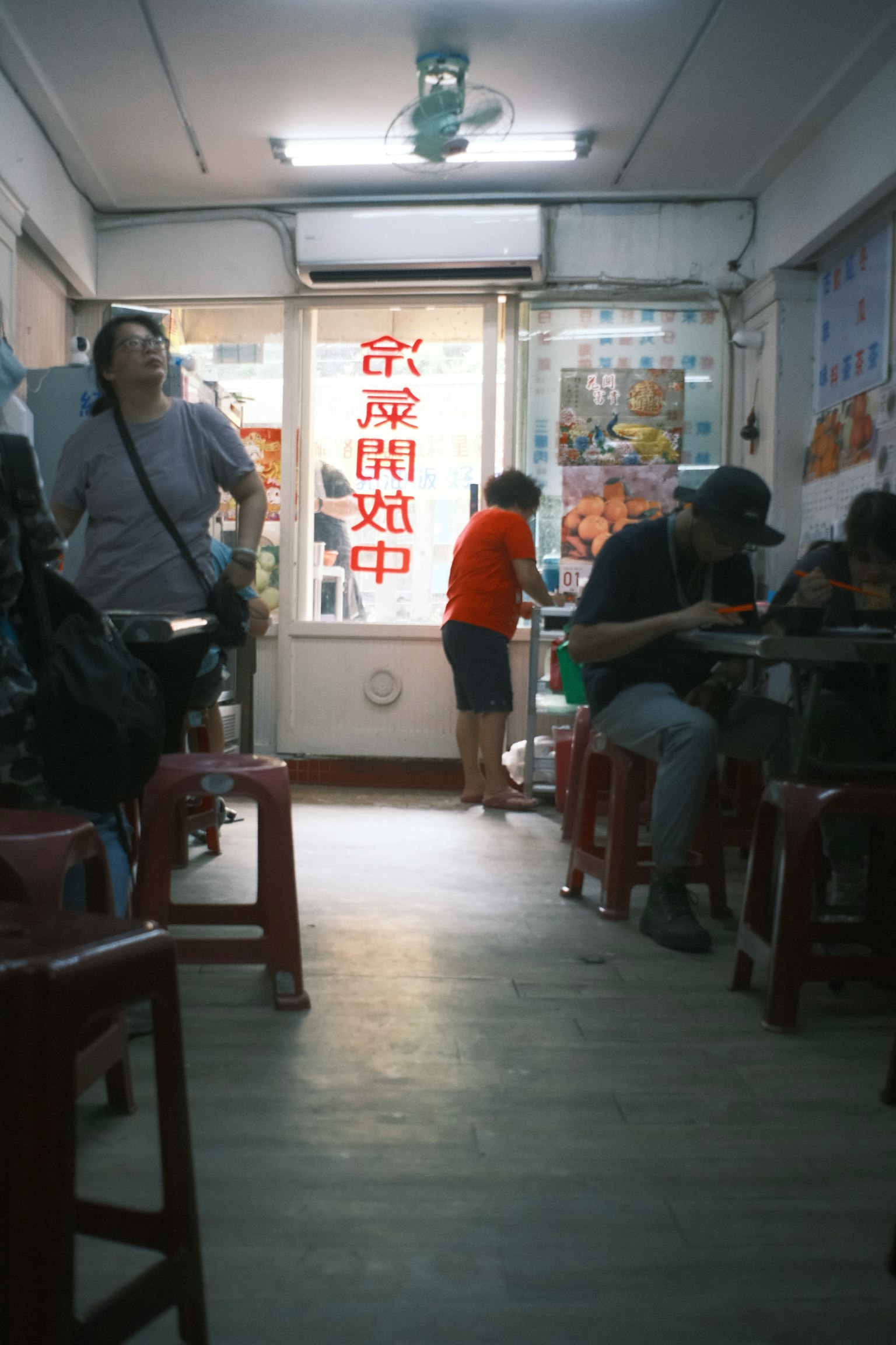 Interior of a casual eatery with people dining and an open door