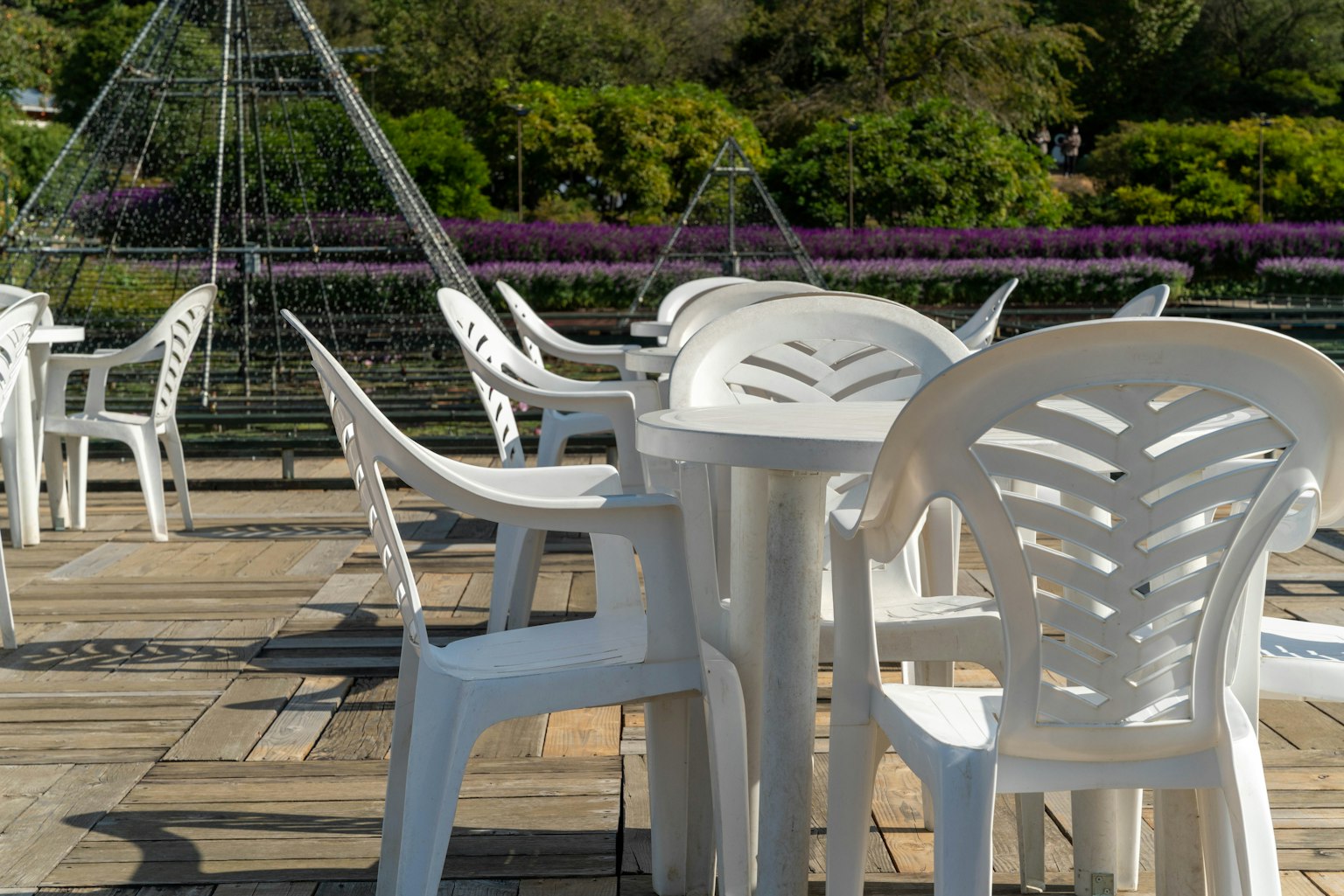 Outdoor café space with white plastic chairs and tables