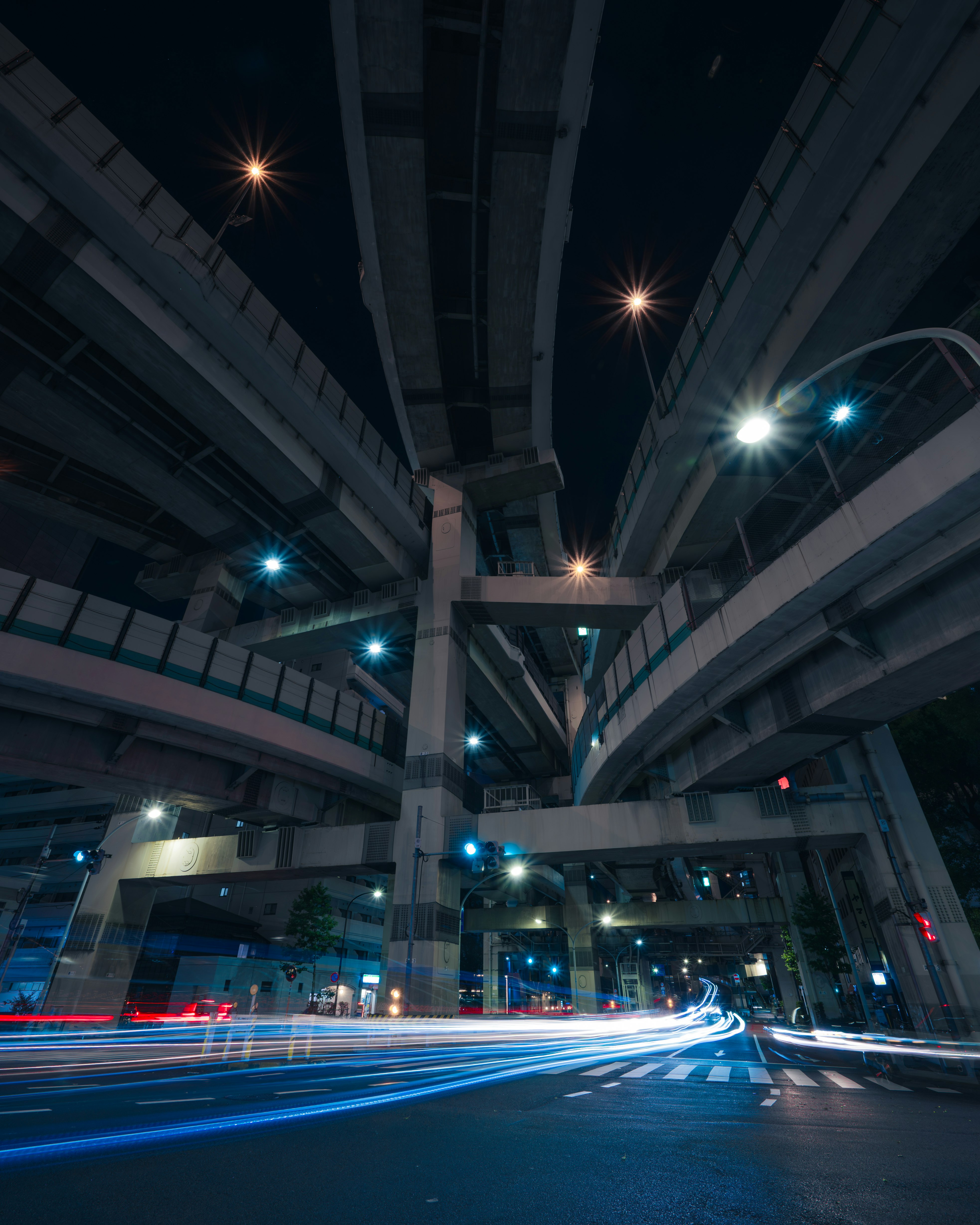 light trails of cars at an underpass intersection