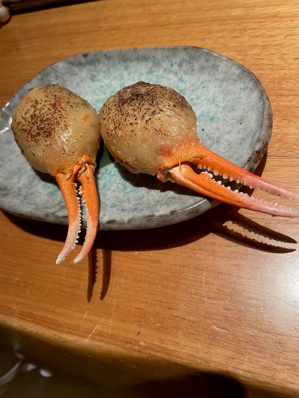 shrimp with shells on a wooden cutting board
