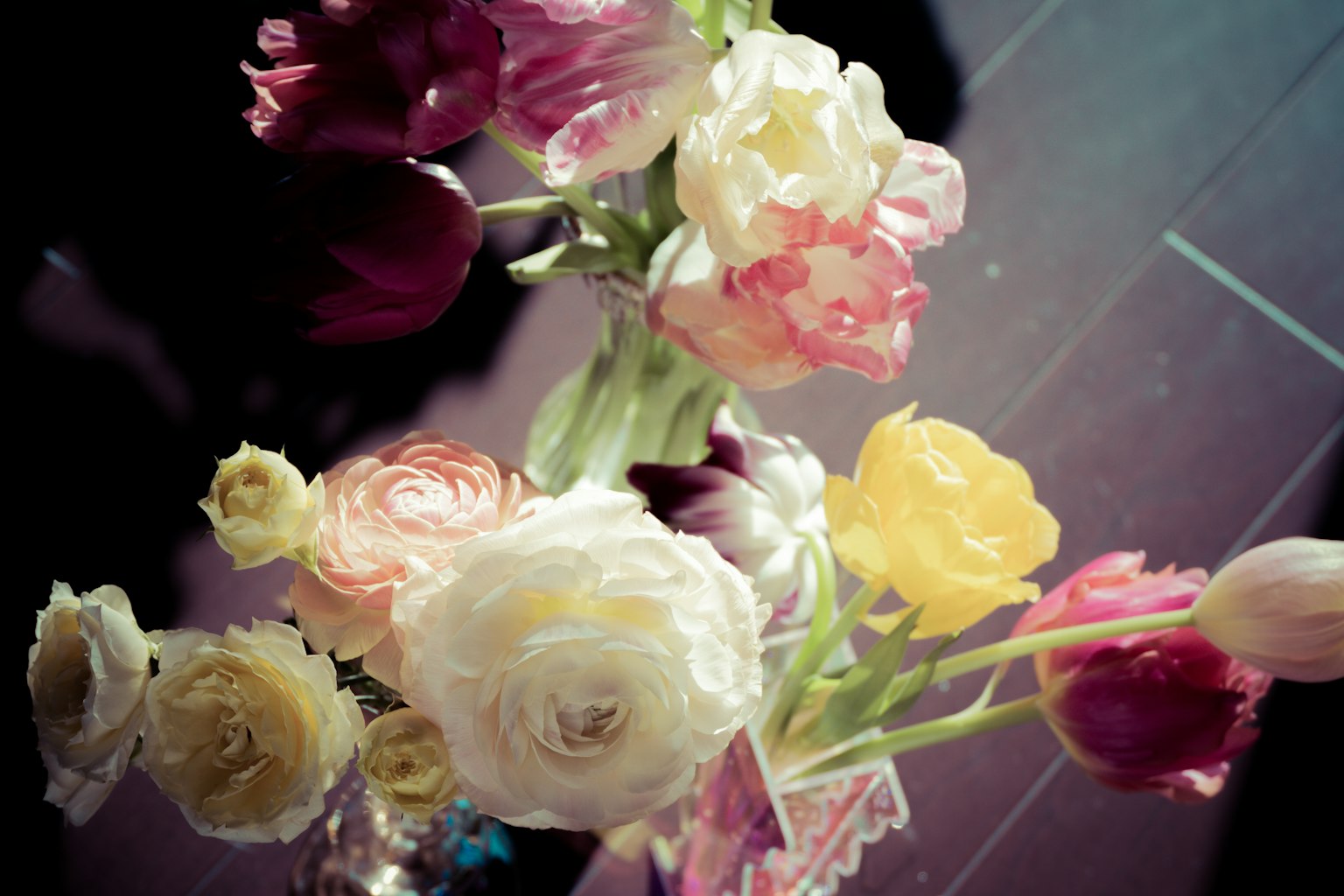 A vibrant bouquet featuring tulips and ranunculus in various colors