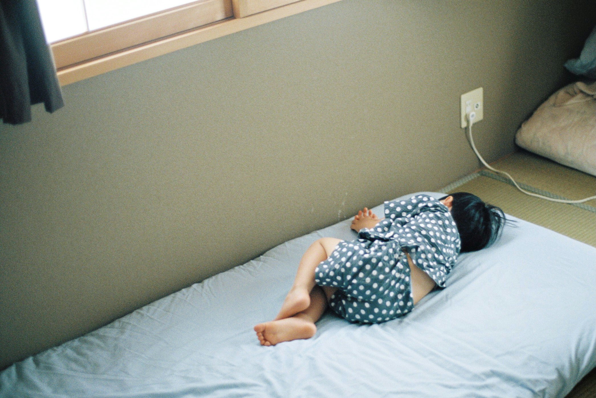 A child sleeping on a bed