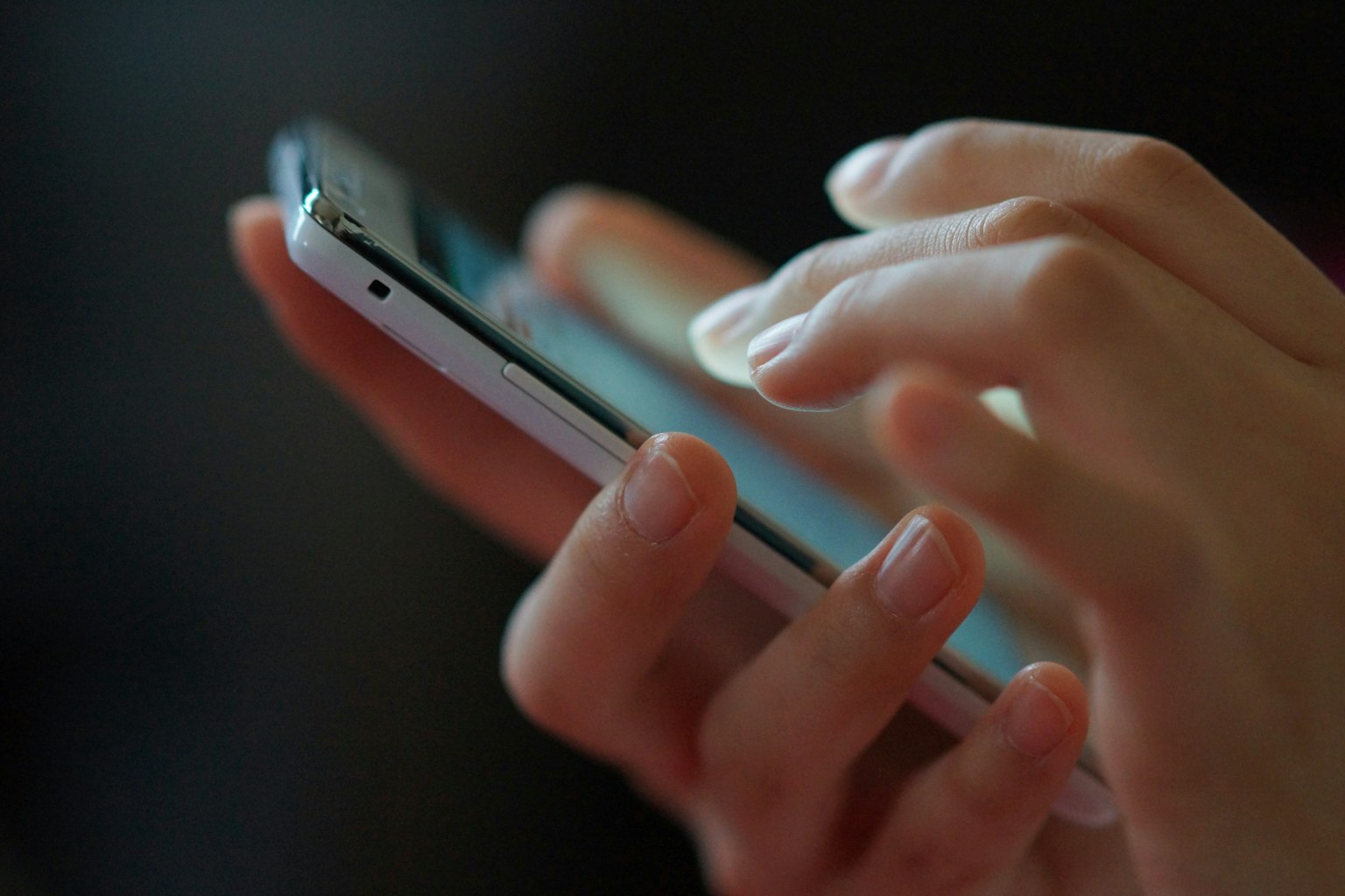 A person using a smartphone with their fingers