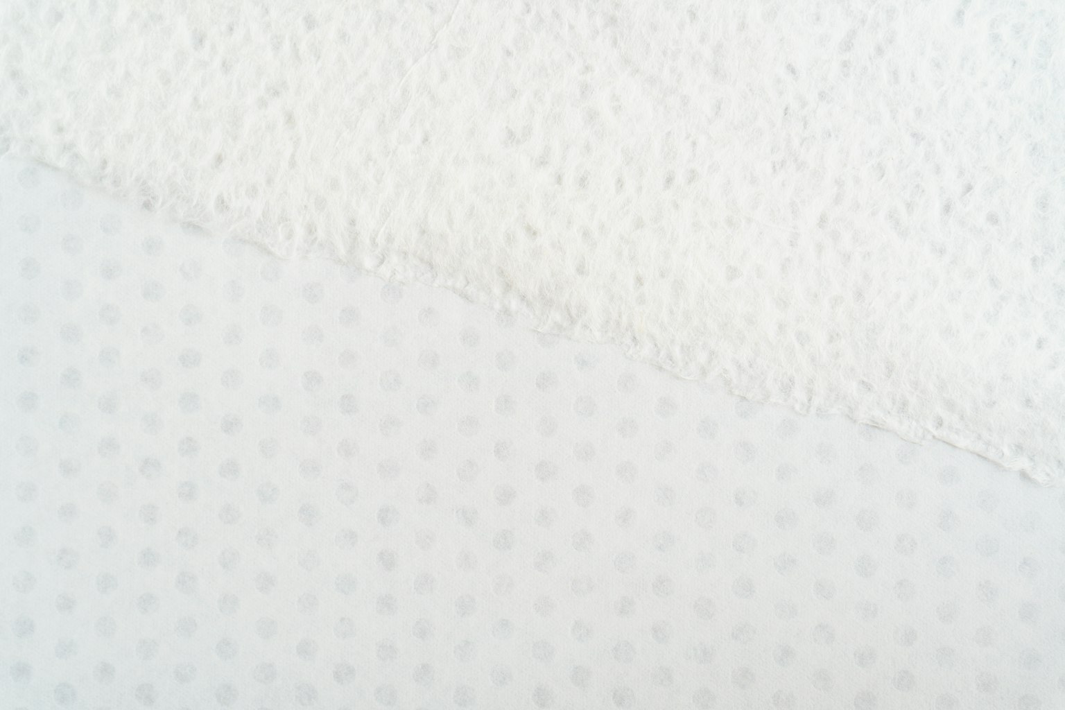 Two different white fabric textures overlapping