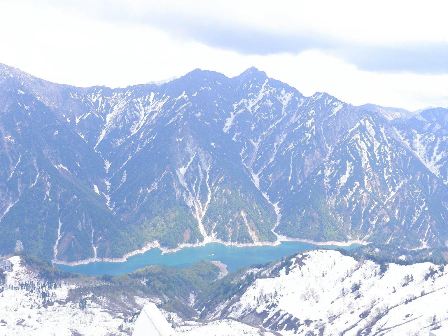 Snow-covered mountains with a blue lake in the valley
