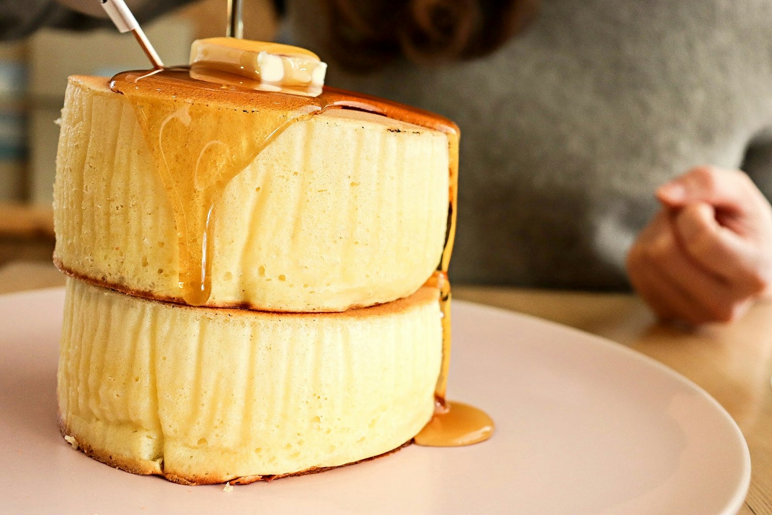 Fluffy pancakes topped with butter and maple syrup