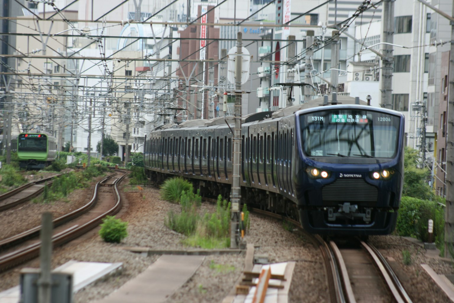 Urban railway scene with train on tracks surrounded by buildings