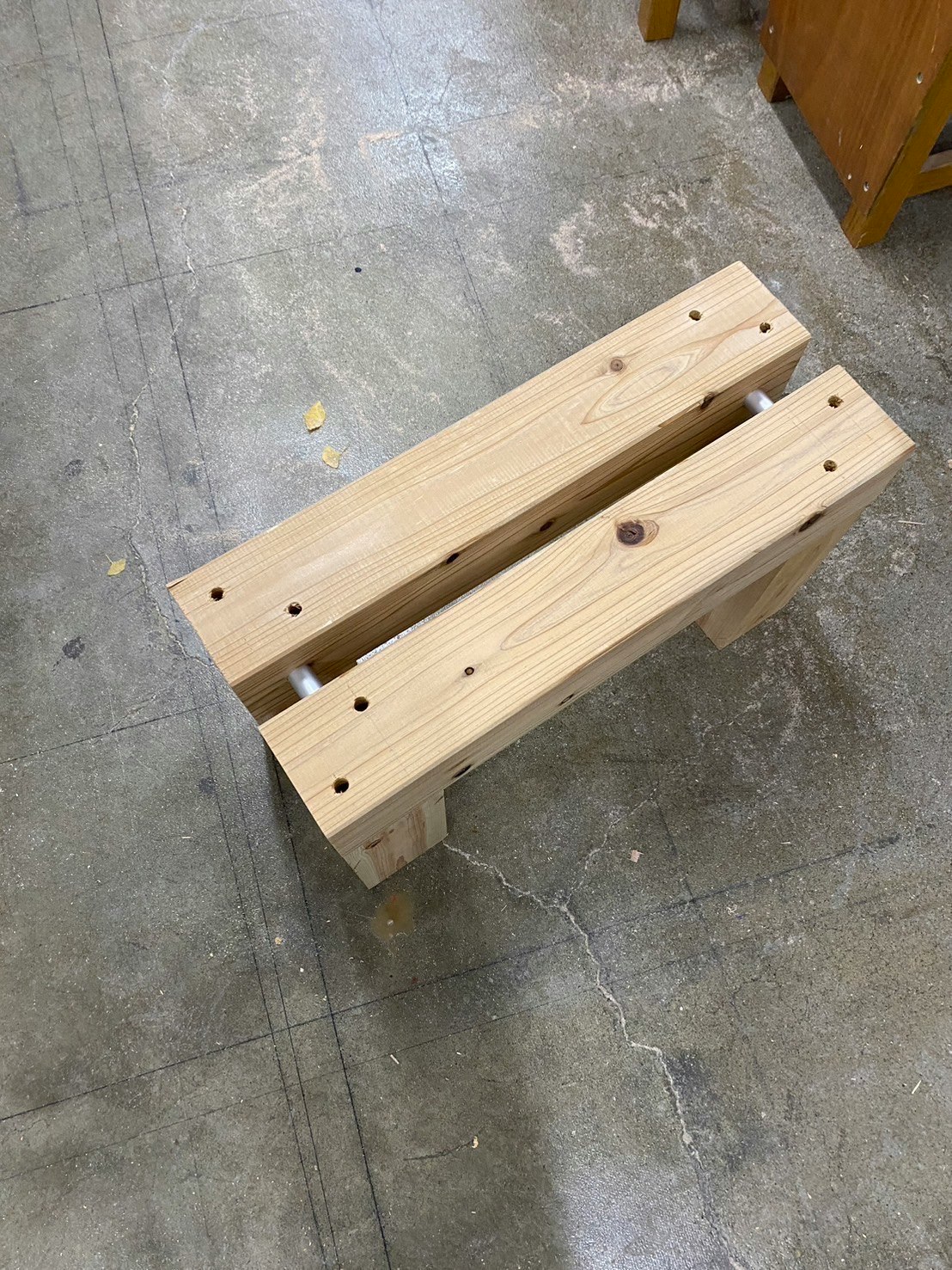 wooden boards and hardware placed on a concrete floor