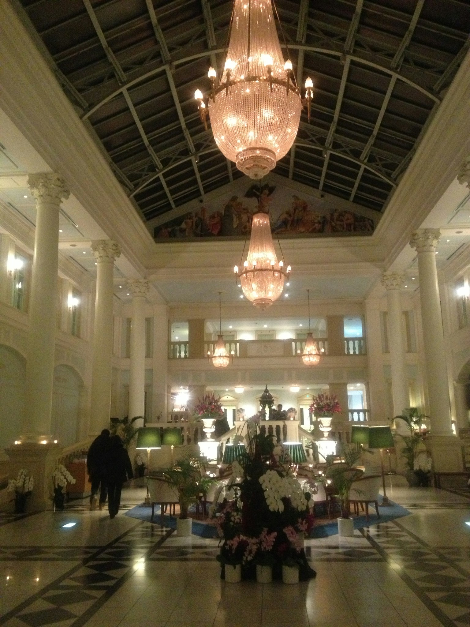 Luxurious lobby interior featuring chandeliers and a high ceiling