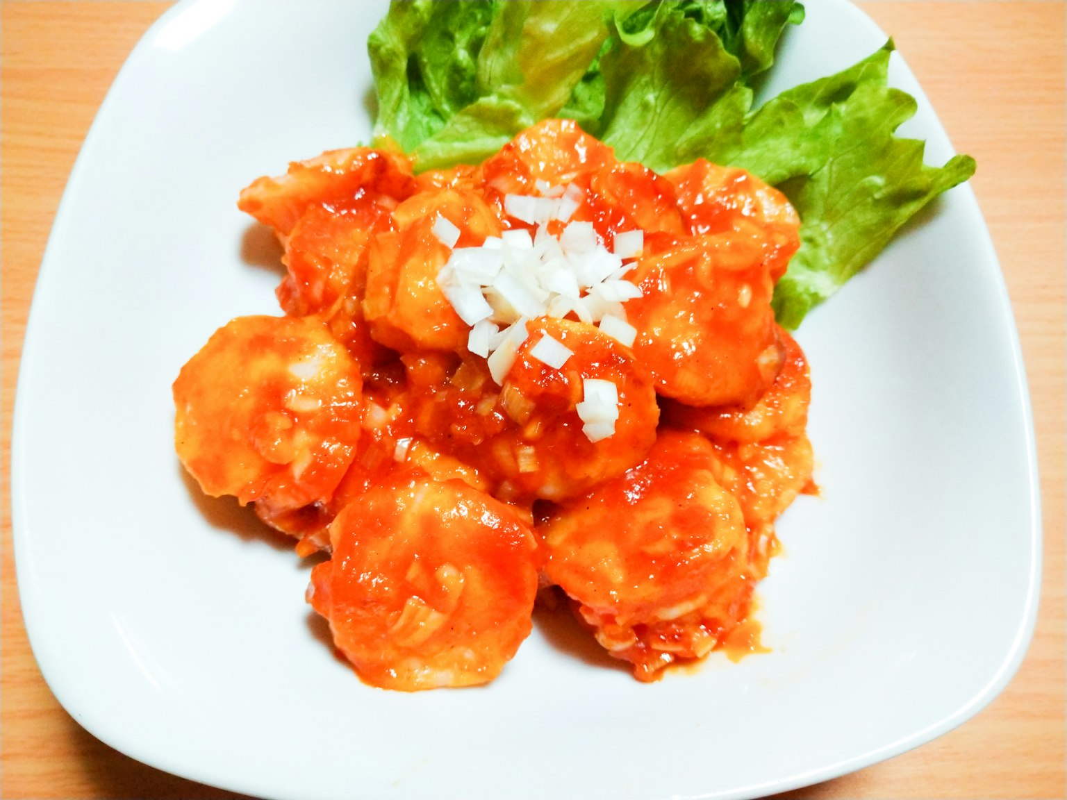 Shrimp dish coated in sweet and spicy sauce served with lettuce