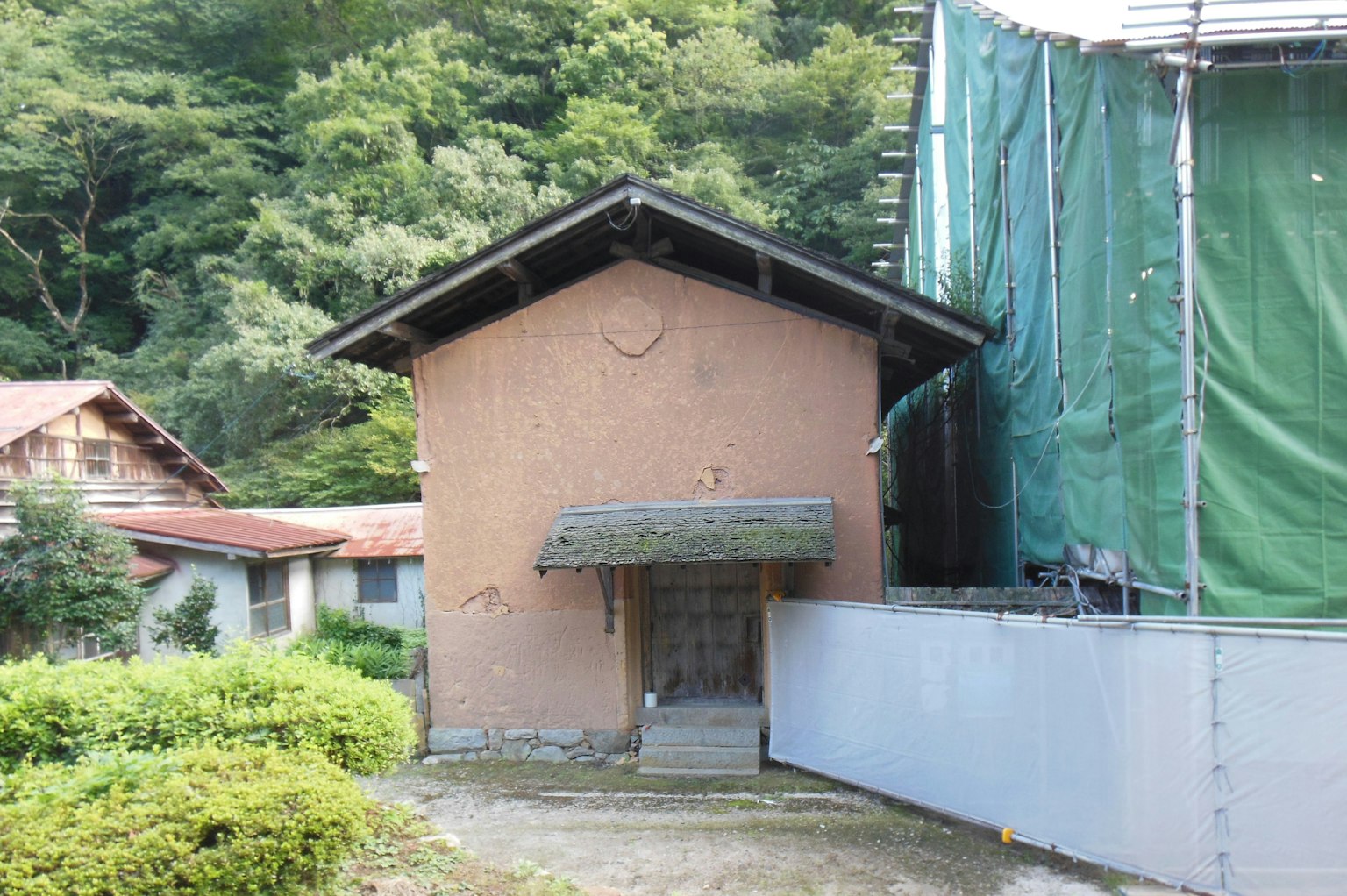 Exterior view of an old building surrounded by greenery
