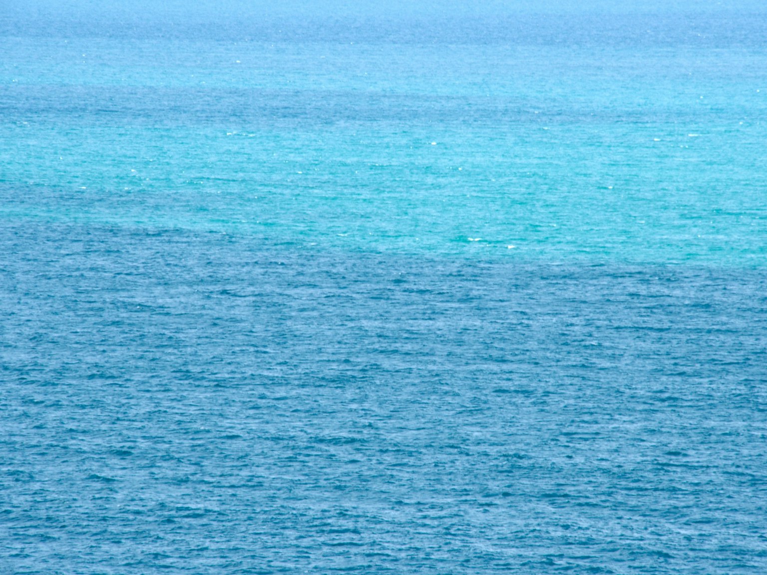 Vista expansiva del océano azul con superficie de agua turquesa