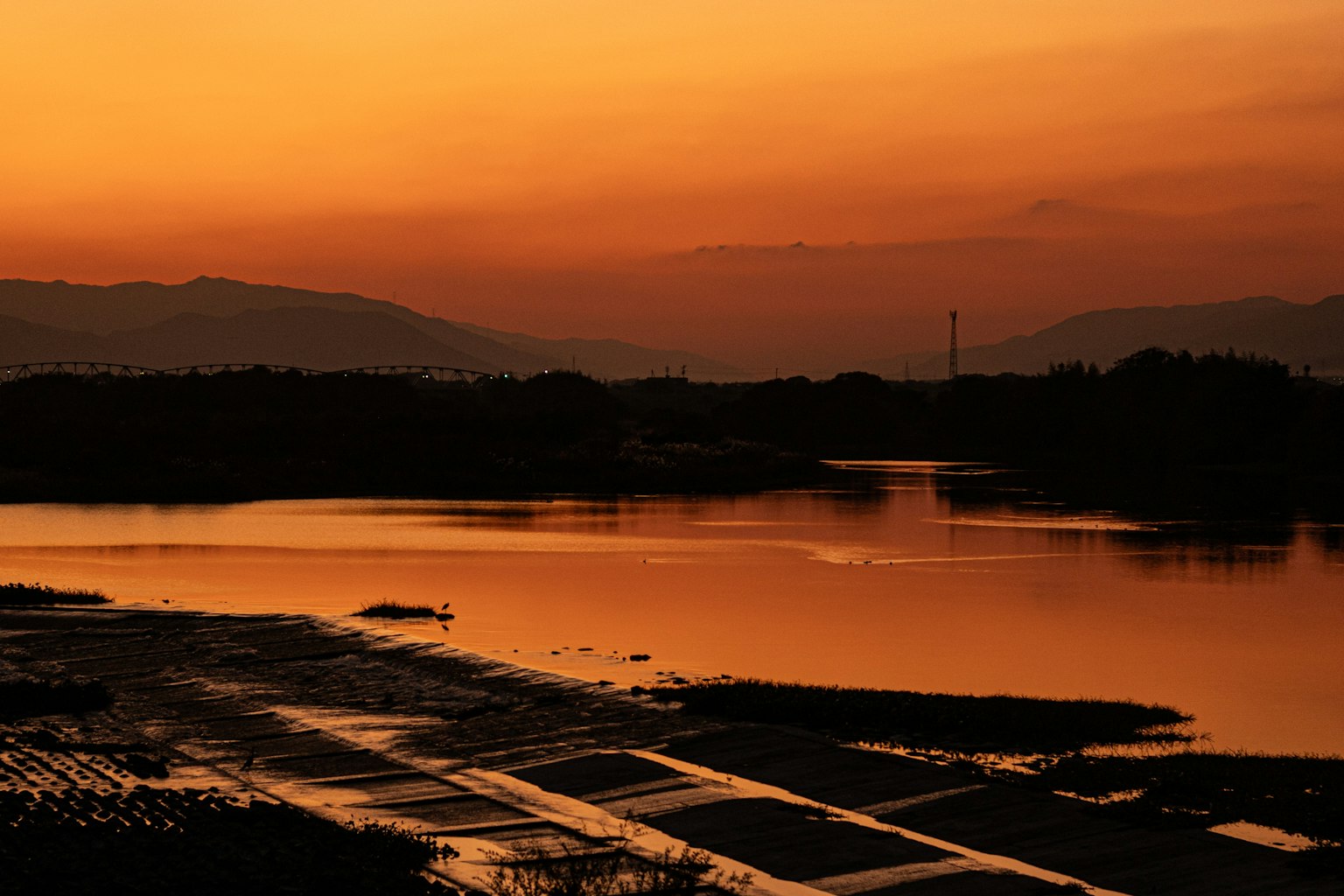 夕焼けの川の風景と静かな水面