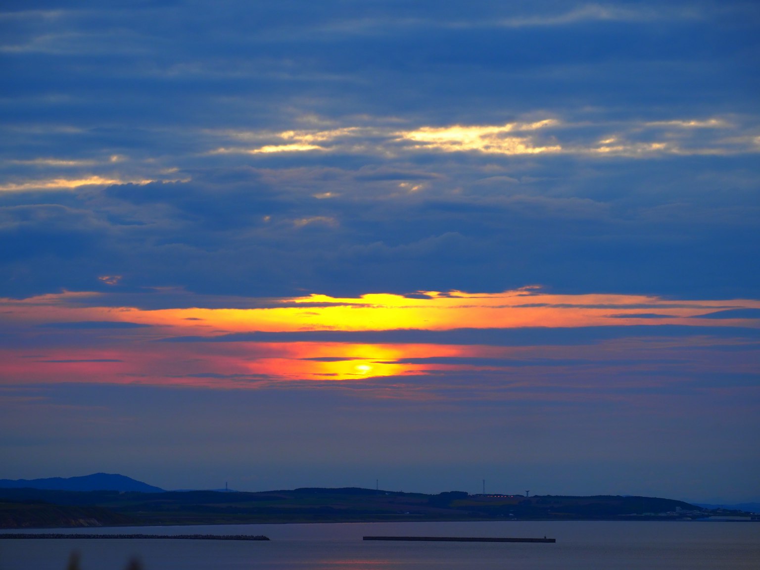 Beautiful sunset with clouds and vibrant colors over the sea and islands