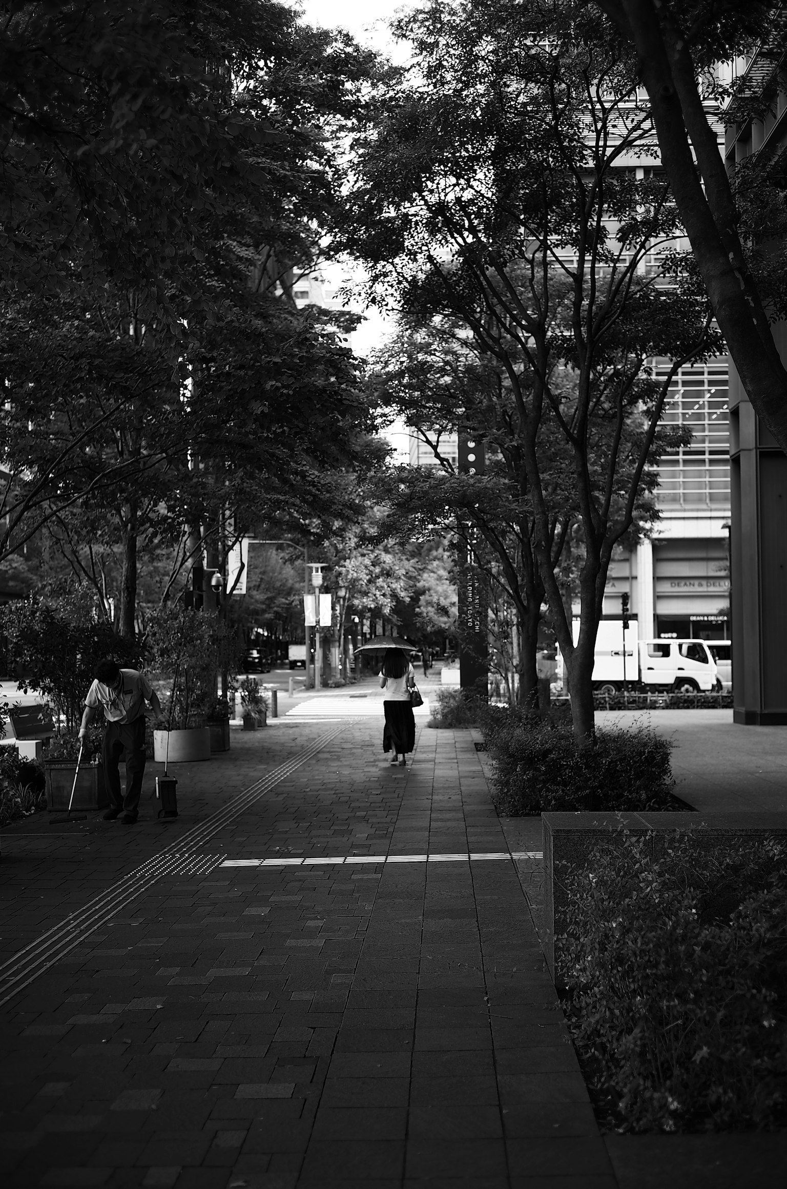 黑白城市場景，街道中間站著一個人