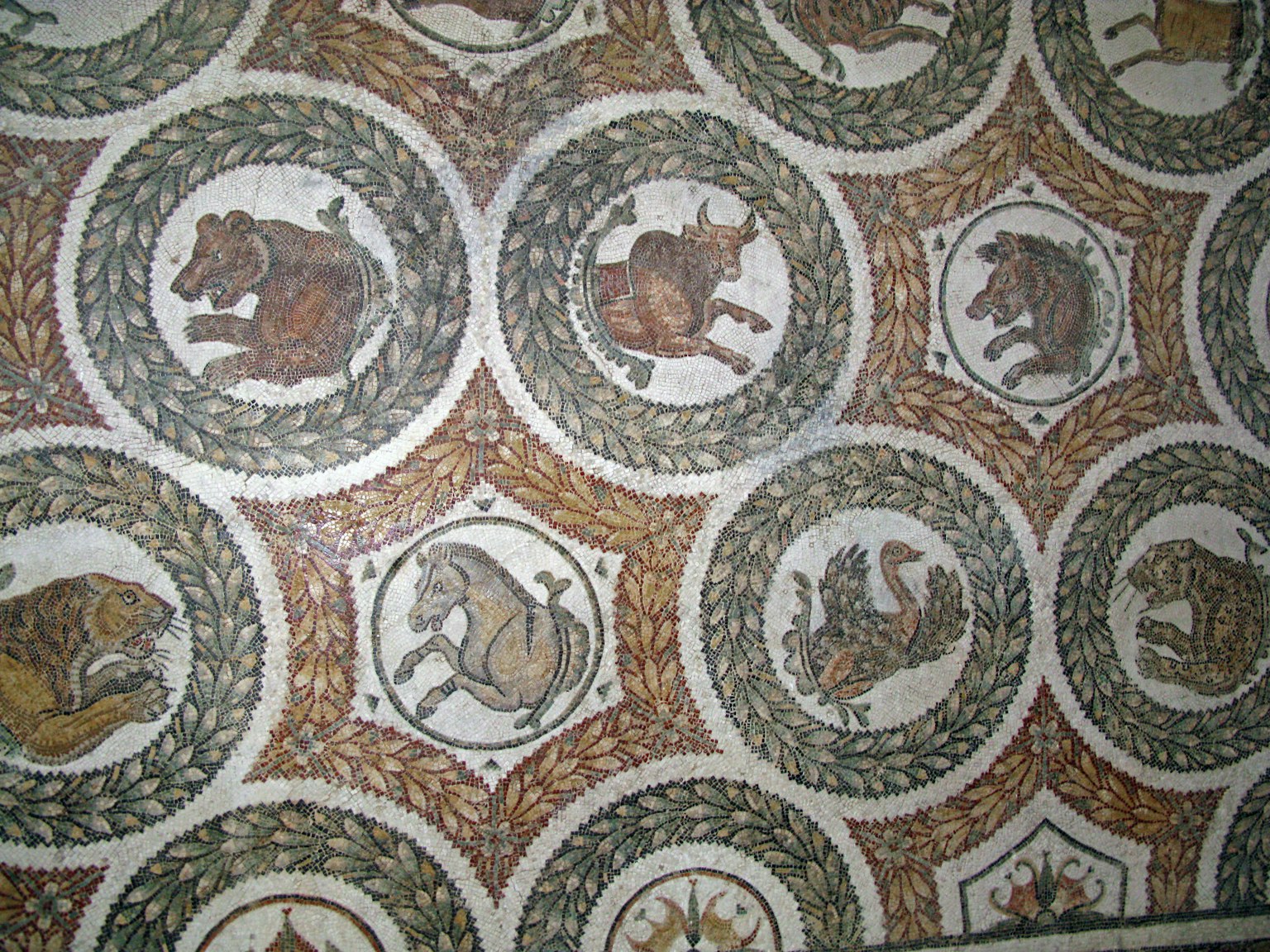 Ancient mosaic floor featuring animal designs and circular patterns