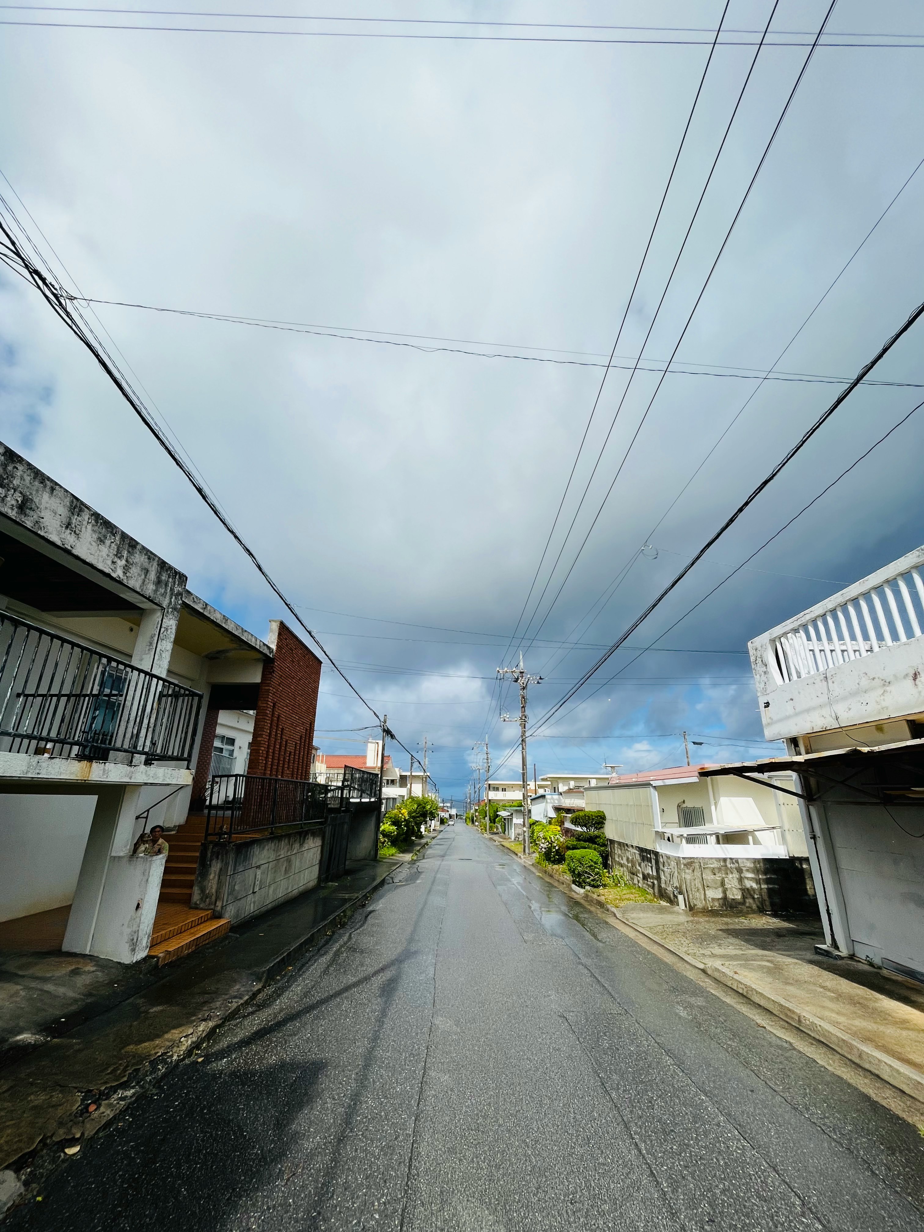 quiet residential street with overhead power lines