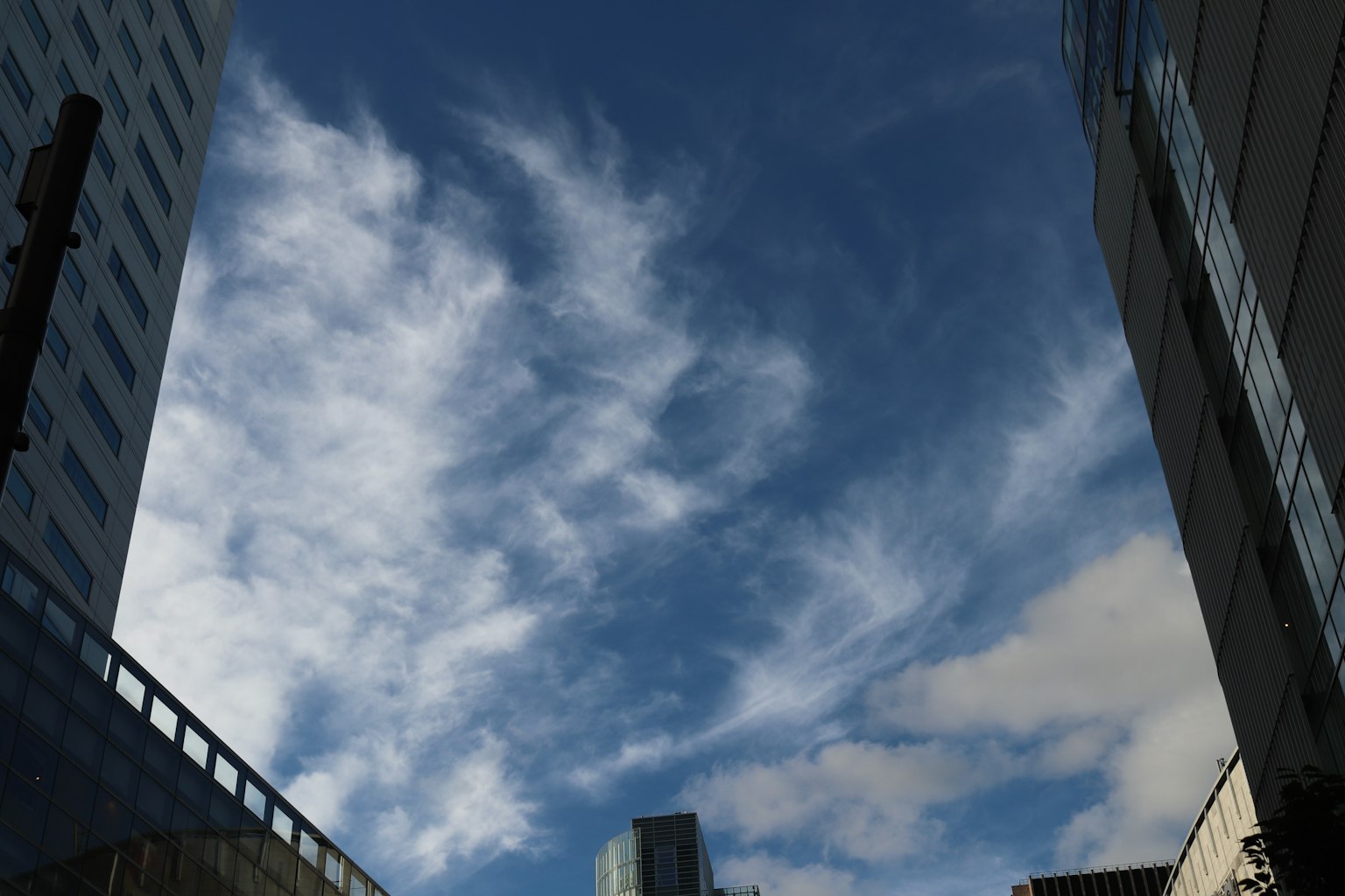 A beautiful view of blue sky and clouds framed by skyscrapers