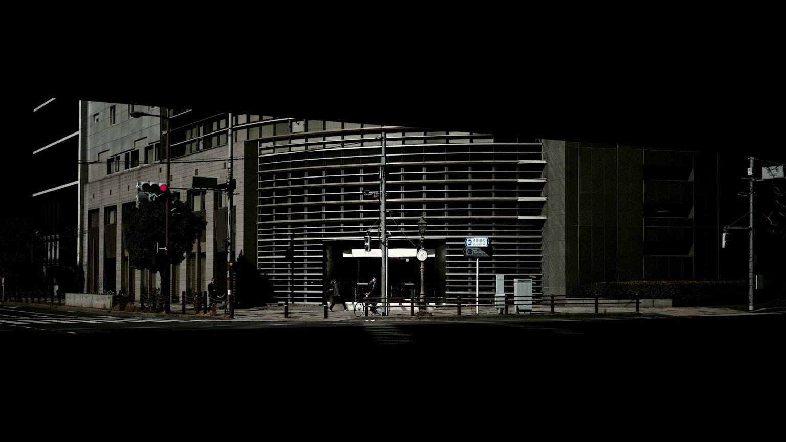 Night cityscape featuring modern buildings and a crosswalk