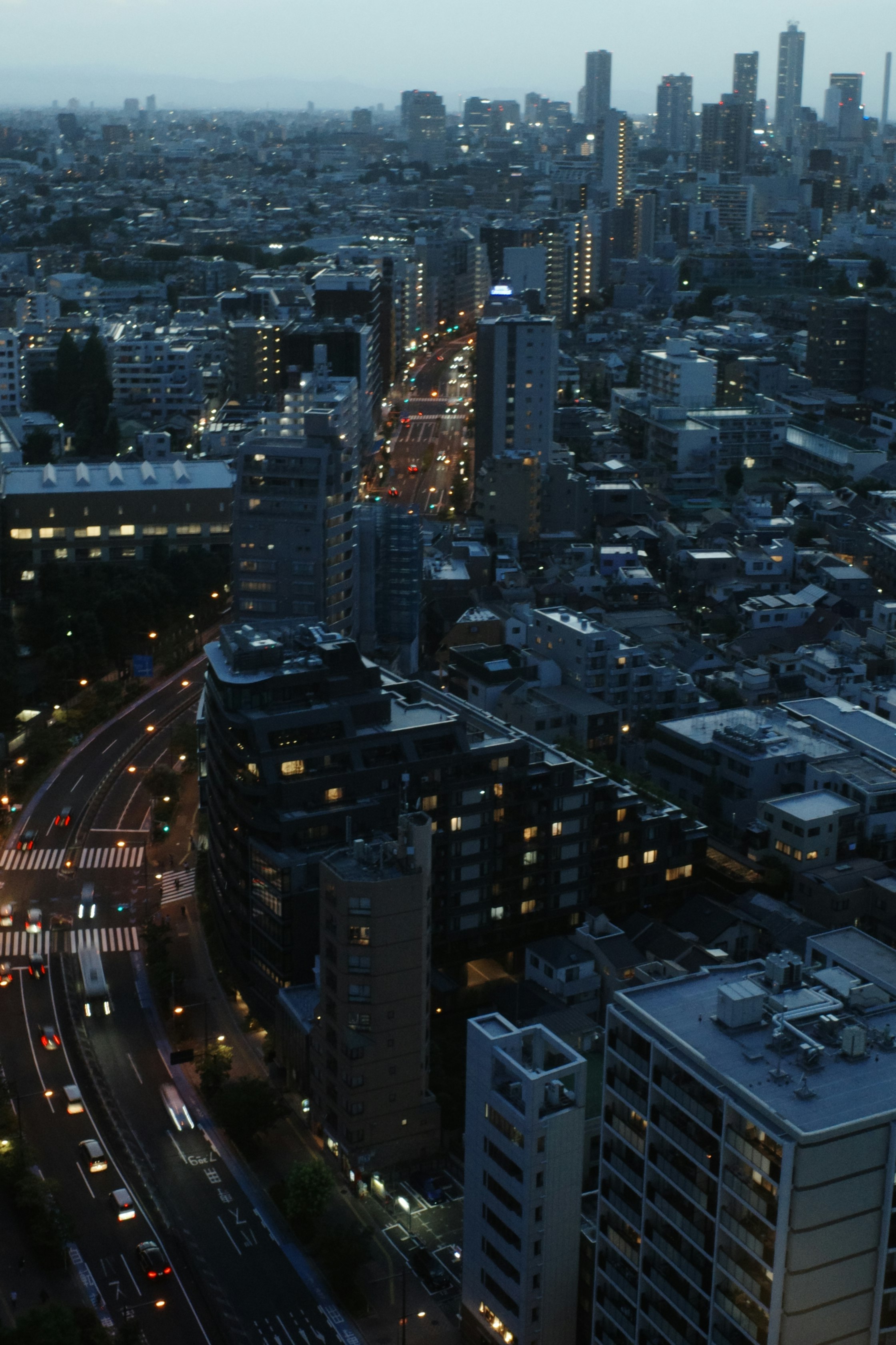 night city skyline over a snowy urban street with tall buildings