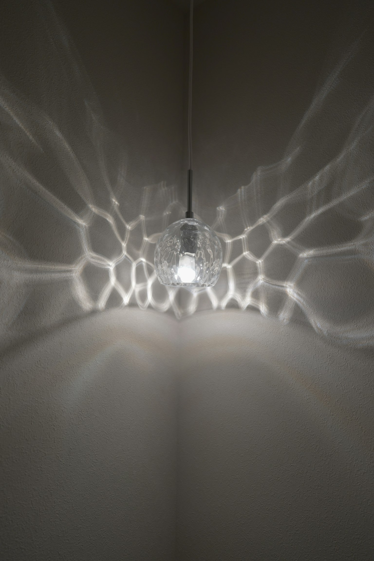 Un lustre lumineux projetant de magnifiques motifs de lumière sur le mur