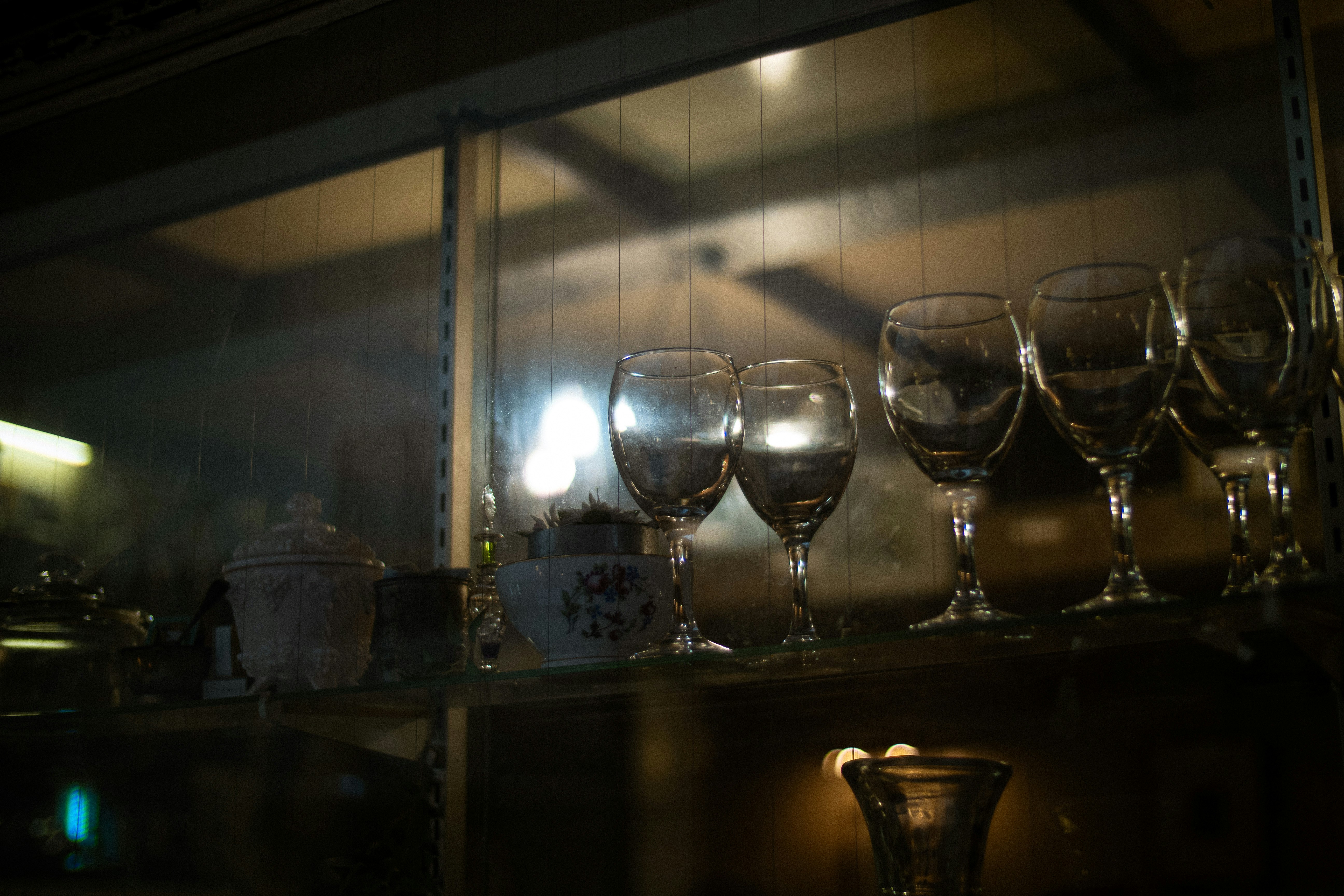 indoor shelf with arranged wine glasses and cups